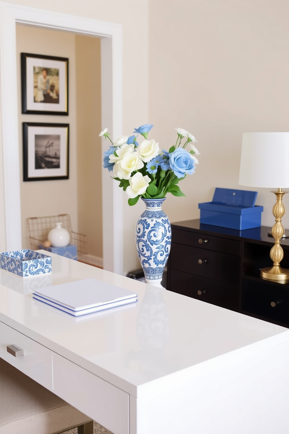 A stylish home office featuring a large wooden desk with a sleek design. The desk is adorned with a laptop and a decorative potted plant with vibrant red and white blooms, adding a touch of color to the workspace. The walls are painted in a soft gray, creating a calming atmosphere. A comfortable ergonomic chair sits beside the desk, while a cozy reading nook with a plush armchair is placed near a window, inviting natural light into the room.