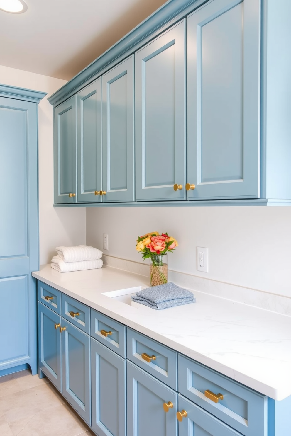 A bright and functional laundry room featuring a statement light fixture that serves as a focal point. The room is equipped with modern appliances and has ample storage space with stylish cabinetry in a soft blue hue. Decorative elements include a woven basket for laundry and wall art that adds a touch of personality. The countertops are made of a durable material, providing both practicality and elegance in this inviting space.