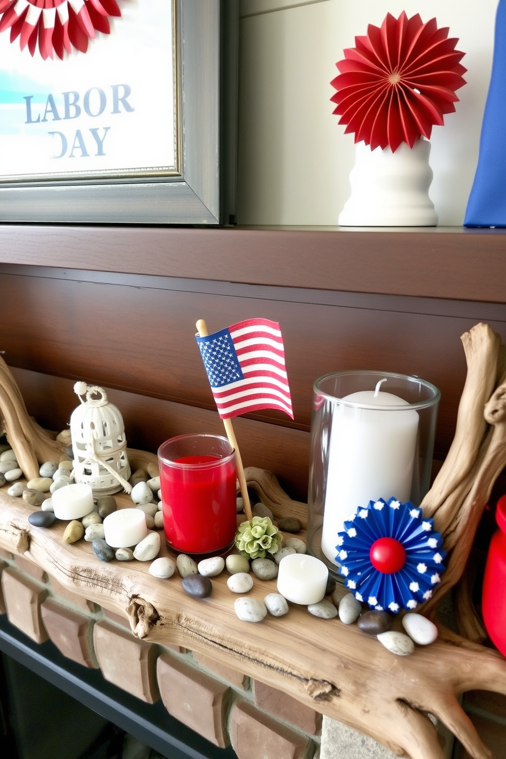 A cozy mantel decorated for Labor Day featuring natural elements like driftwood and smooth stones. The driftwood serves as a rustic base, adorned with small white candles and scattered pebbles, while vibrant red, white, and blue accents reflect the holiday spirit.