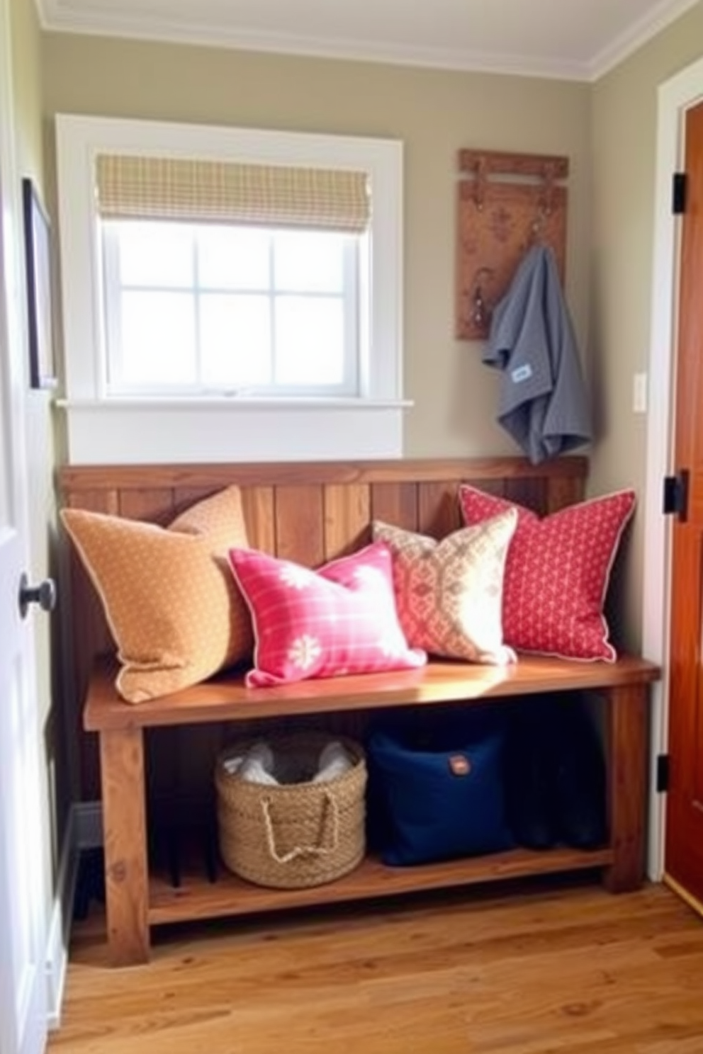 A cozy mudroom features a rustic wooden bench adorned with colorful cushions in vibrant hues. The space is illuminated by natural light streaming through a nearby window, creating a warm and inviting atmosphere.