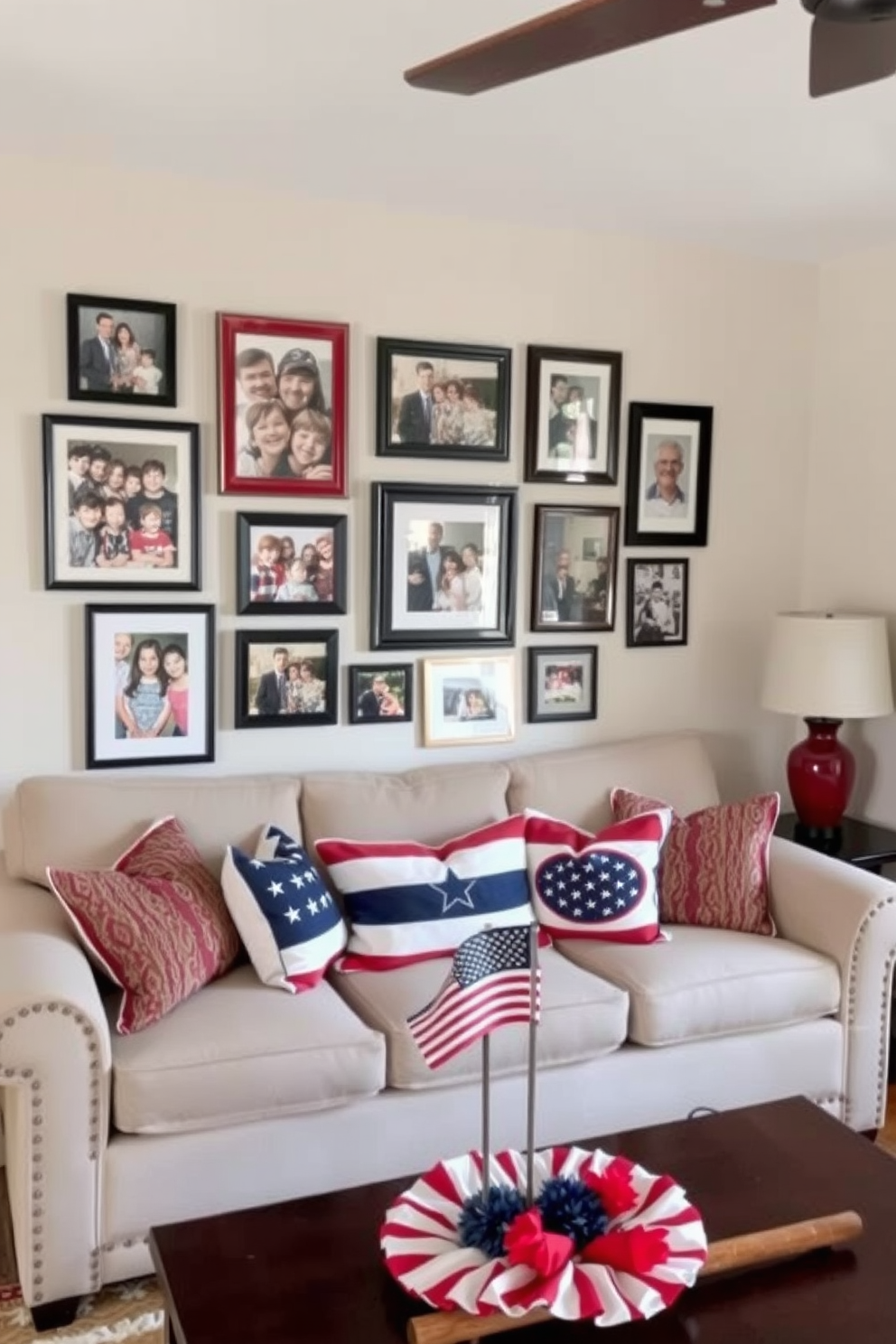 A cozy small living room features a gallery wall adorned with family photos in various frames showcasing cherished memories. The space is decorated for Labor Day with patriotic accents such as red, white, and blue throw pillows on a comfortable sofa and a festive table centerpiece.