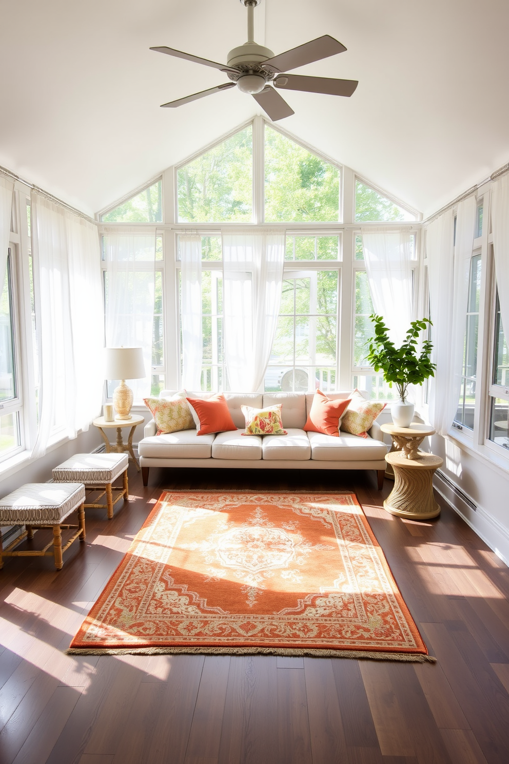 A bright and inviting sunroom filled with natural light. The space features large windows with sheer white curtains, allowing the sunlight to filter through softly. In the center, a comfortable seating arrangement consists of a plush sectional sofa adorned with colorful throw pillows. A decorative area rug in warm tones anchors the seating area, adding a touch of coziness to the room.