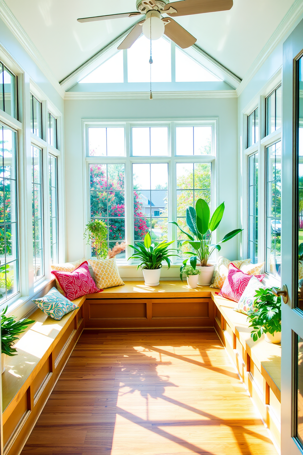 A bright and inviting sunroom features built-in benches adorned with colorful cushions for comfortable seating. Large windows allow natural light to flood the space, showcasing vibrant plants and a cozy atmosphere perfect for relaxation.