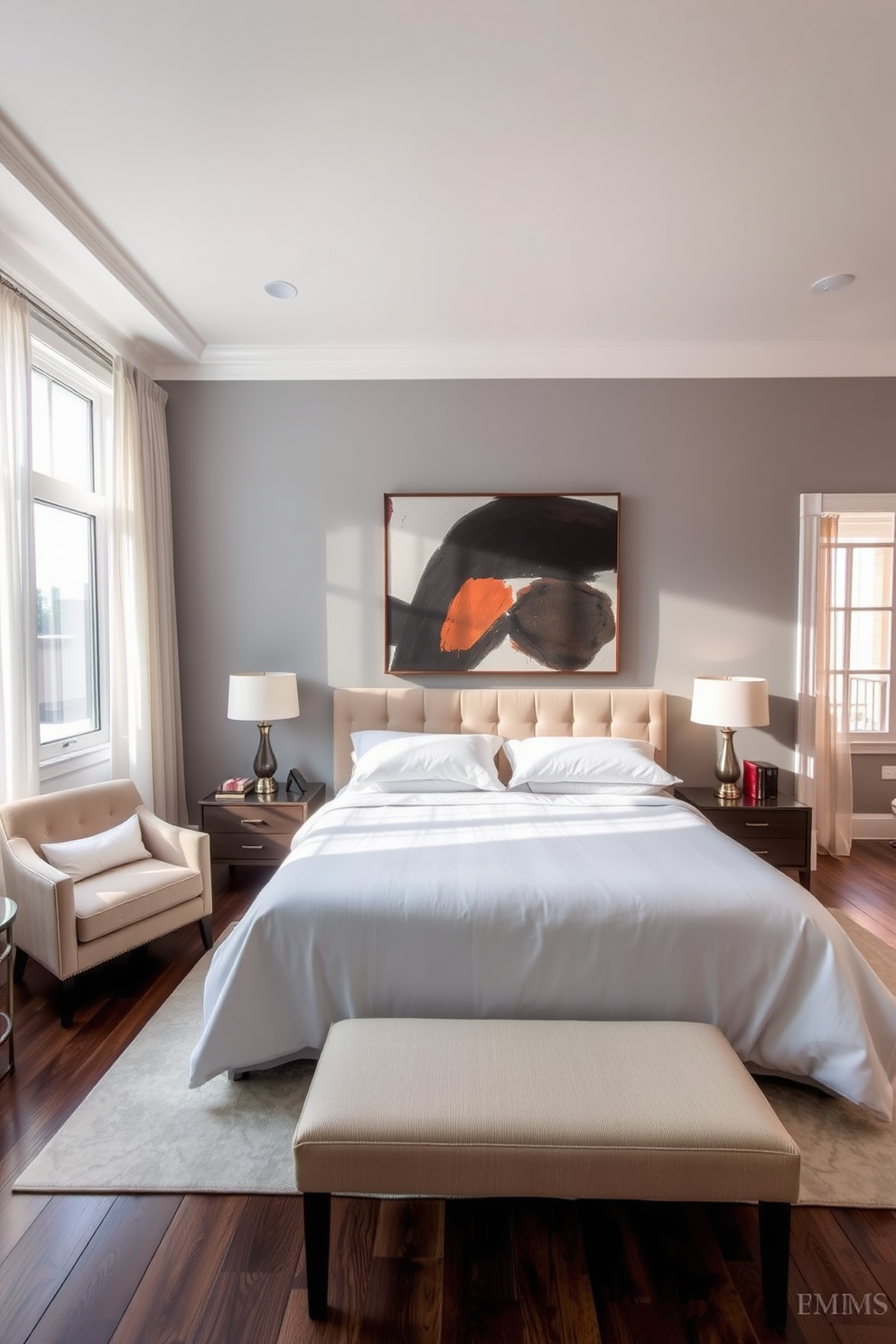 A spacious bedroom featuring a king-sized bed with a plush upholstered headboard and crisp white linens. The walls are painted in a soft gray, and a large, bold artwork hangs above the bed, adding a striking focal point to the room. A cozy reading nook is situated in one corner with a stylish armchair and a small side table. Natural light floods the space through large windows adorned with sheer curtains, creating an inviting atmosphere.