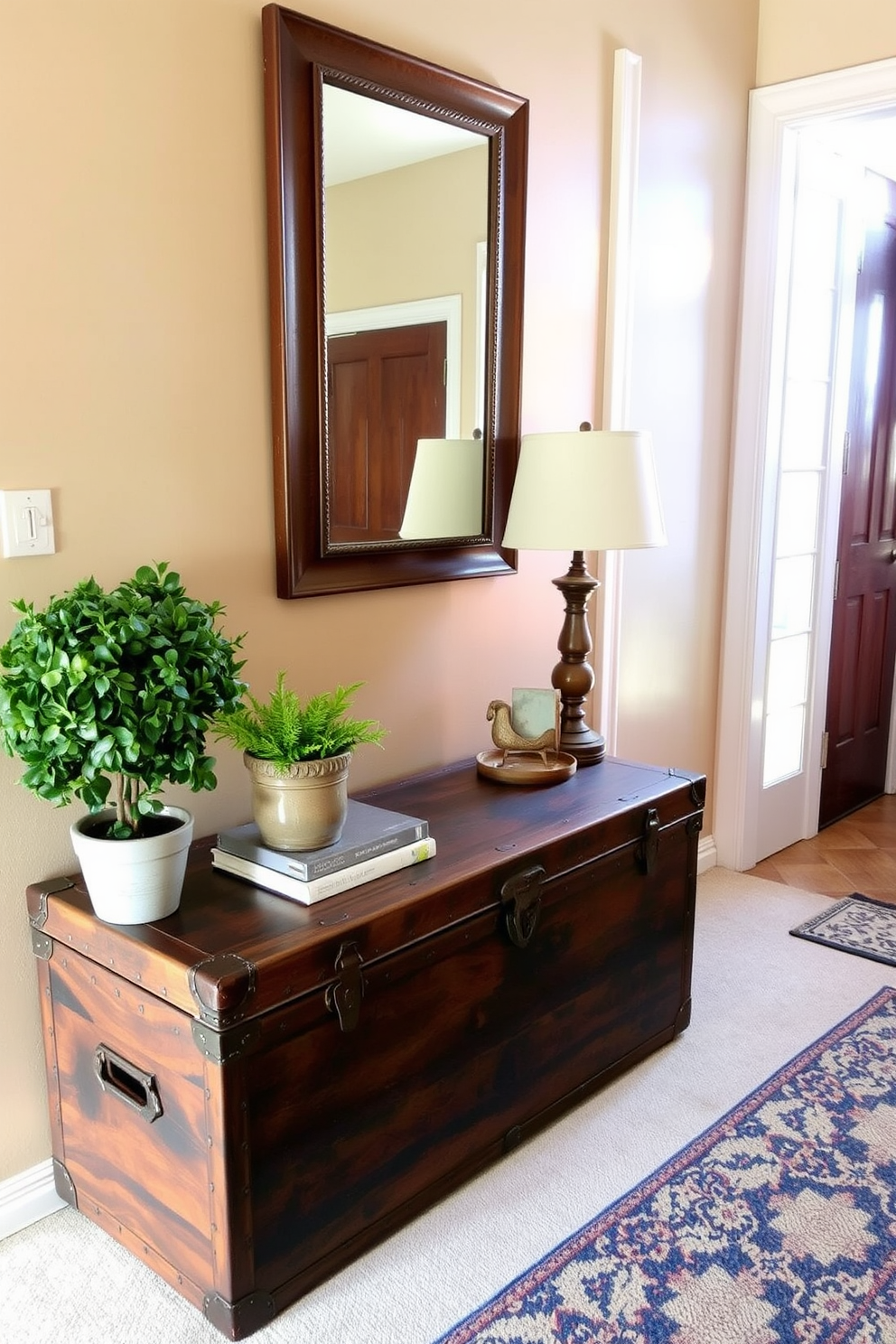 A vintage trunk serves as a stylish entryway table, adding character and charm to the space. The trunk is adorned with decorative elements like a small potted plant and a vintage lamp, creating a warm and inviting atmosphere. The walls are painted in a soft beige hue, complementing the rich wood tones of the trunk. A large mirror hangs above the trunk, reflecting light and enhancing the sense of openness in the entryway.