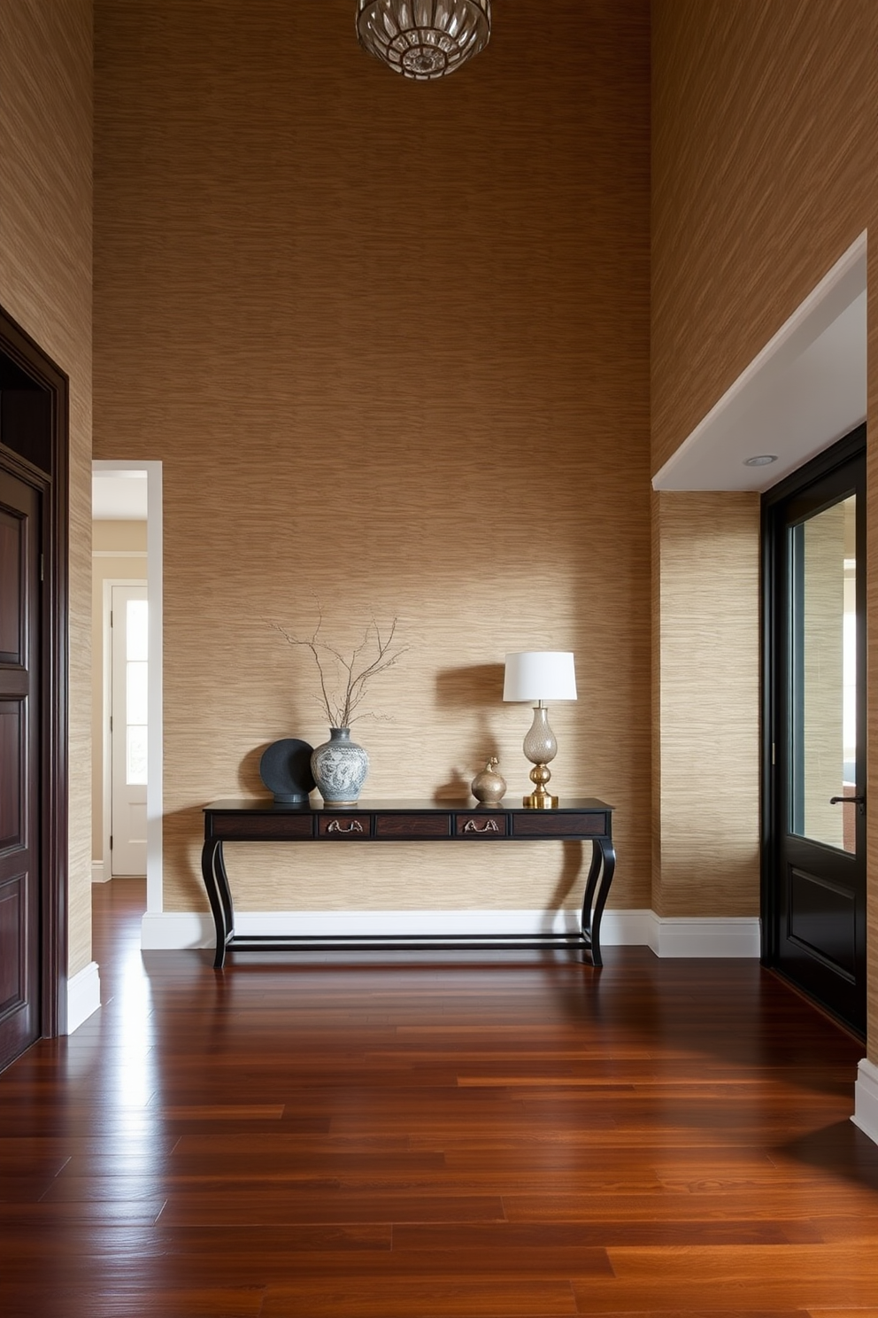 A welcoming doormat is placed at the entrance featuring a personalized message that adds a touch of warmth and hospitality. The large entryway showcases a grand chandelier hanging from a high ceiling, illuminating the space with soft light.