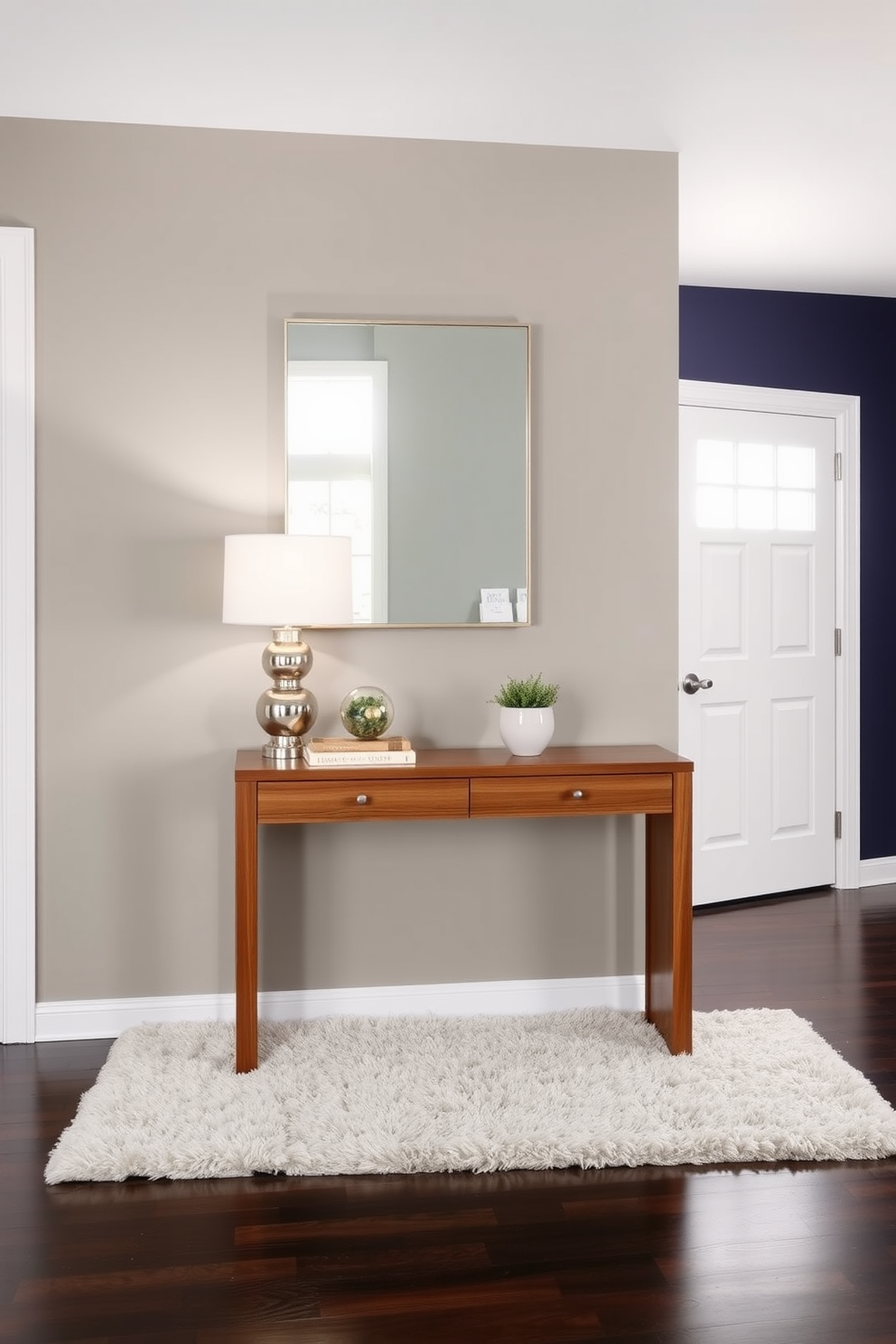 A sleek console table made of polished wood sits against the wall in a spacious entryway. The table is adorned with decorative accents including a stylish lamp, a small potted plant, and a chic mirror above it that reflects the light from a nearby window. The entryway features a bold accent wall painted in a rich navy blue, creating a striking backdrop for the console table. A plush area rug lies beneath the table, adding warmth and texture to the space while complementing the overall design aesthetic.