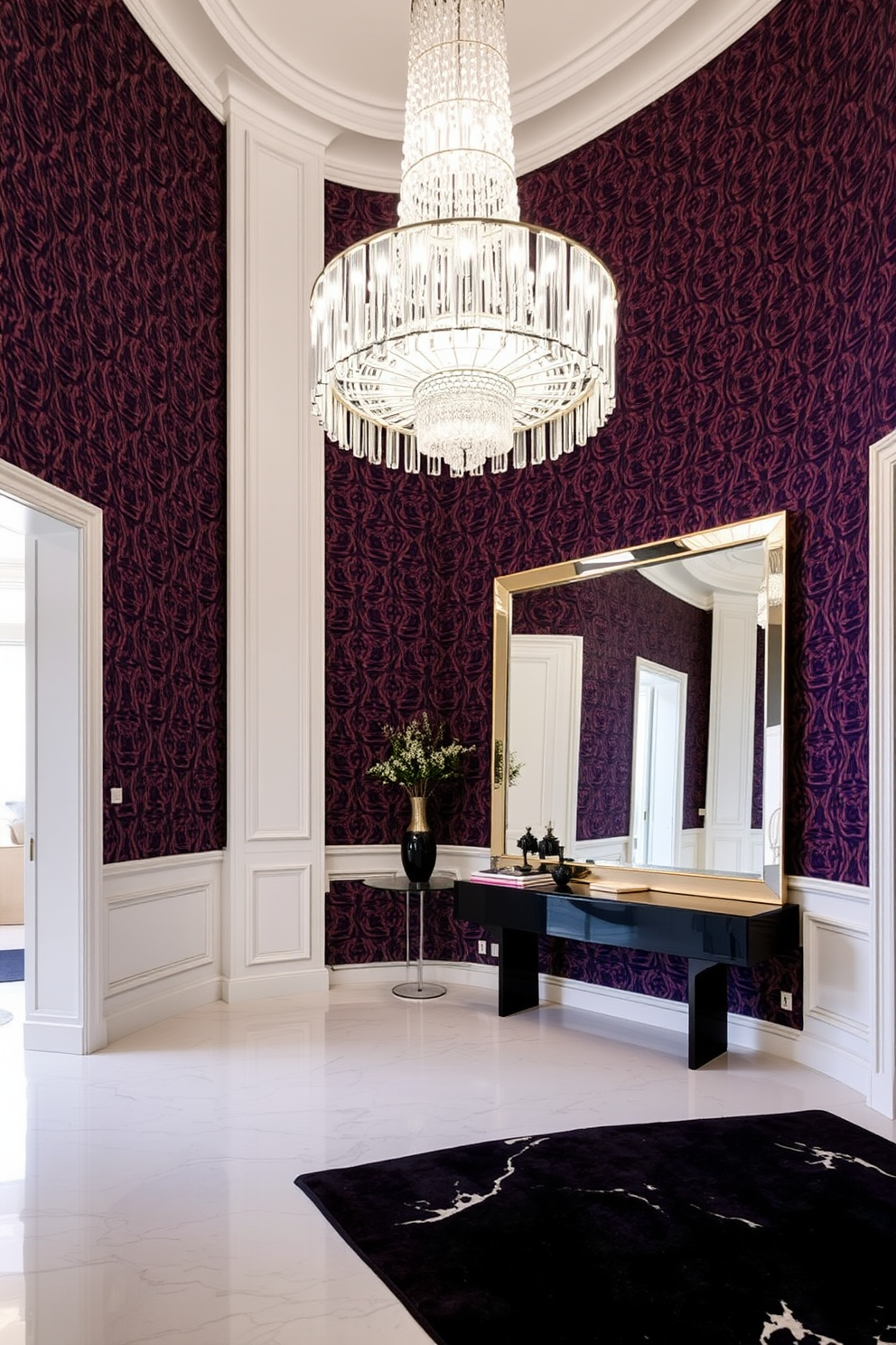 A stunning foyer with bold wallpaper that features an intricate pattern in rich colors. The space is illuminated by a grand chandelier that hangs from a high ceiling, creating a dramatic entrance. A sleek console table sits against the wall, adorned with decorative objects and a large mirror that reflects the vibrant wallpaper. The floor is finished with polished marble tiles, enhancing the luxurious feel of the foyer.