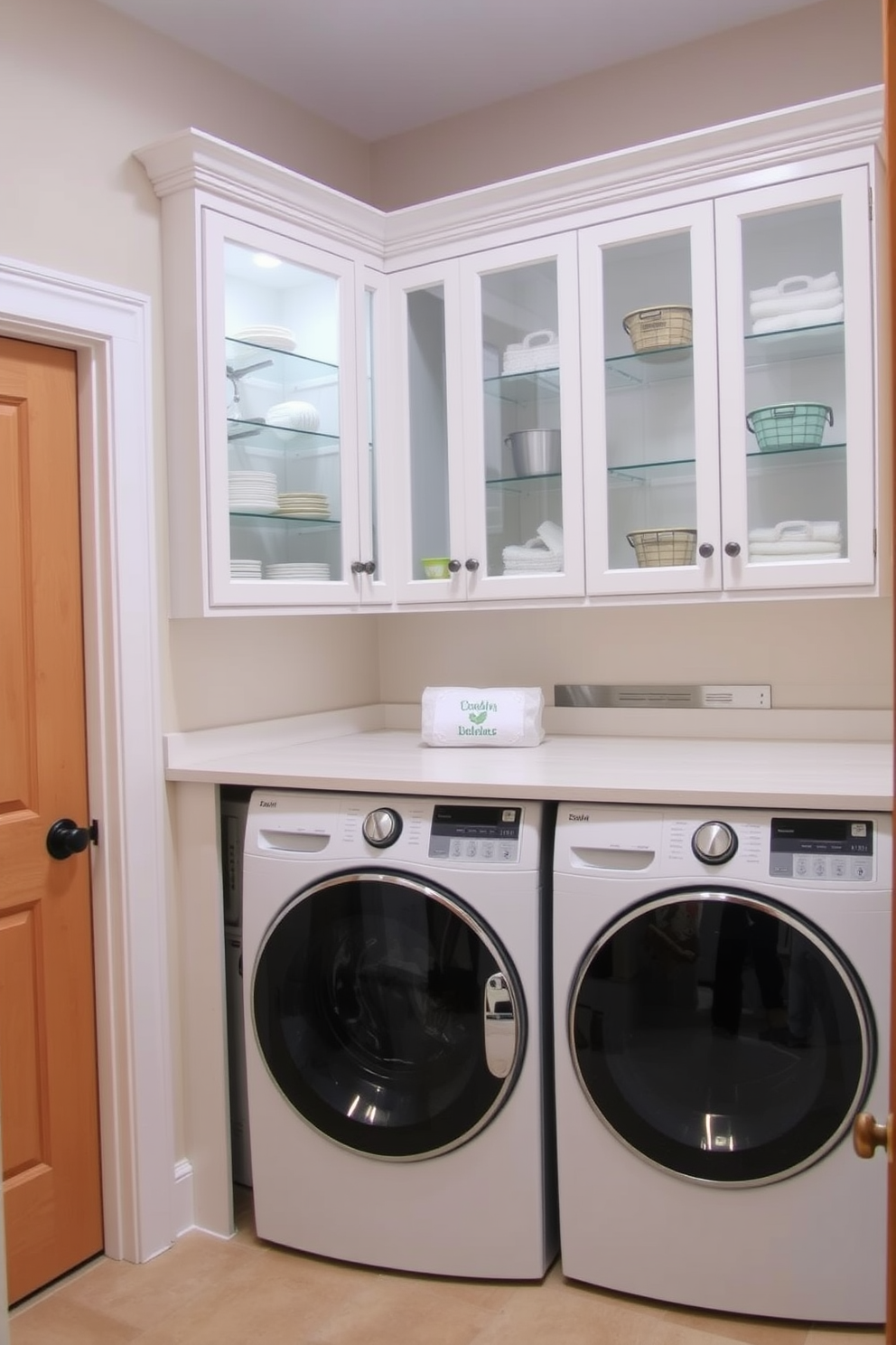 A stylish laundry mudroom features glass front cabinets showcasing neatly arranged display items. The cabinets are complemented by a spacious countertop for folding laundry, and the walls are painted in a soft, inviting color.