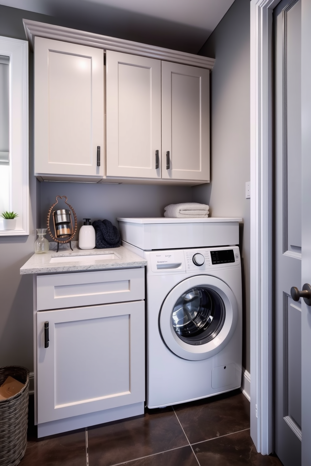 A modern laundry room design featuring a washer dryer combo unit seamlessly integrated into the cabinetry. The walls are painted in a soft gray hue, and the floor is adorned with sleek, dark tiles for a contemporary look.