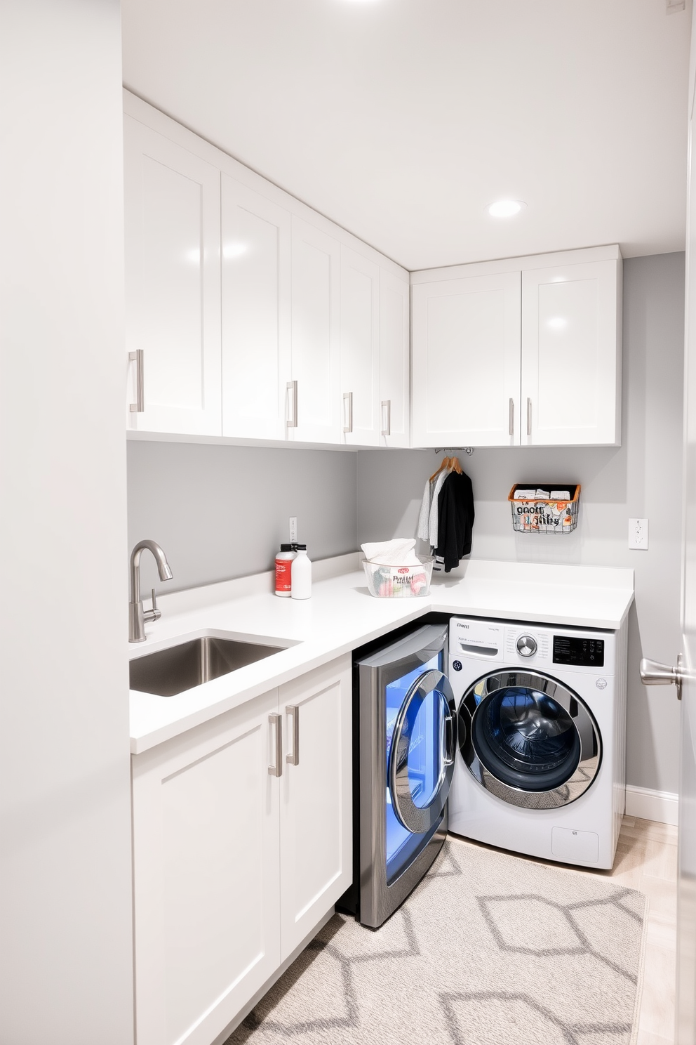 A modern laundry room in a basement with sleek cabinetry and a spacious countertop for folding clothes. The room features a small fridge for beverages, providing convenience while doing laundry, and has a utility sink for easy cleanup. The walls are painted a soft gray, complementing the white cabinetry and countertops. Bright LED lighting illuminates the space, while a stylish area rug adds warmth and comfort underfoot.