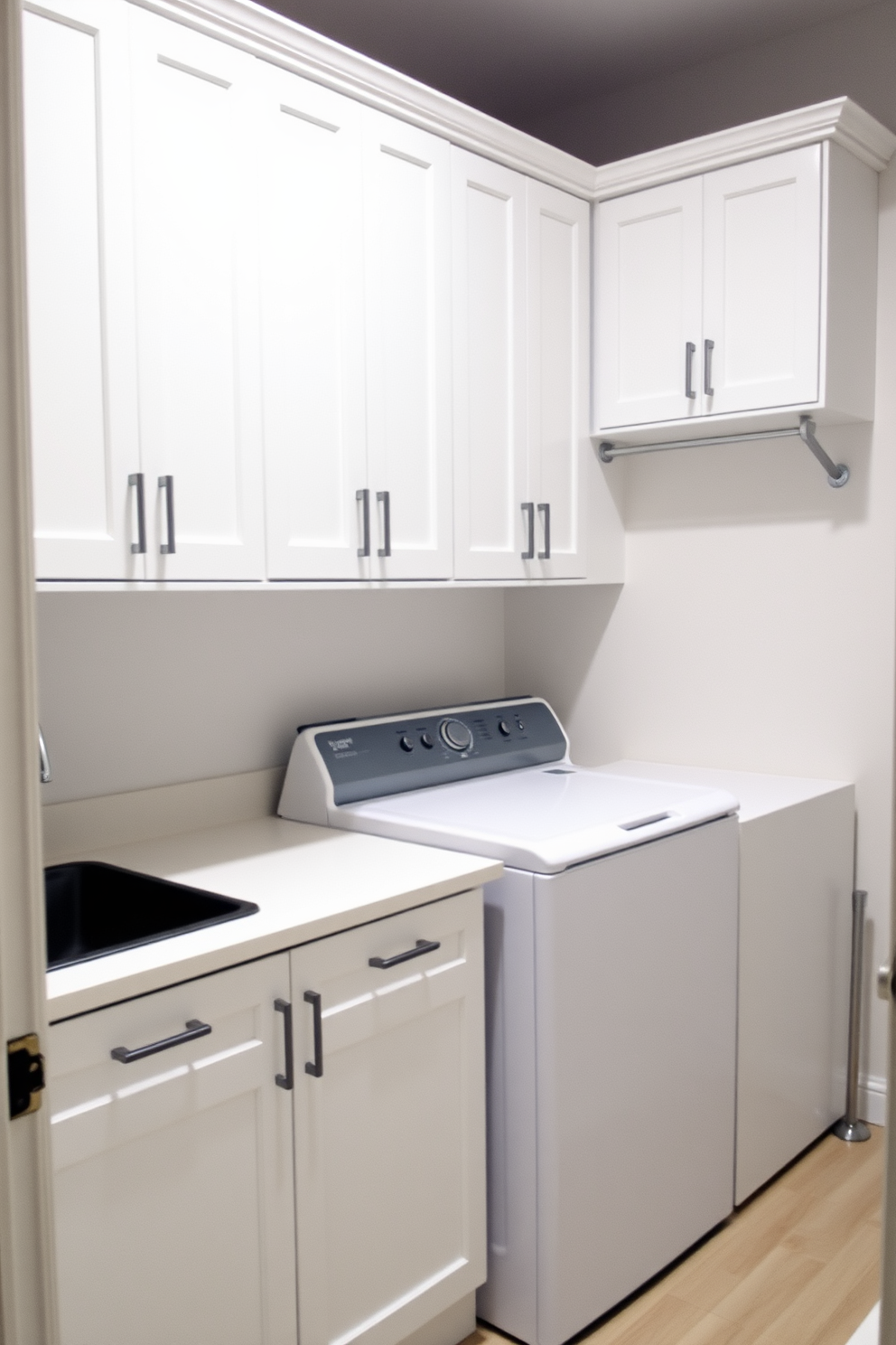 A functional laundry room featuring cabinets with a built-in ironing board. The cabinets are sleek and modern, finished in a soft white hue, providing ample storage space for laundry essentials.