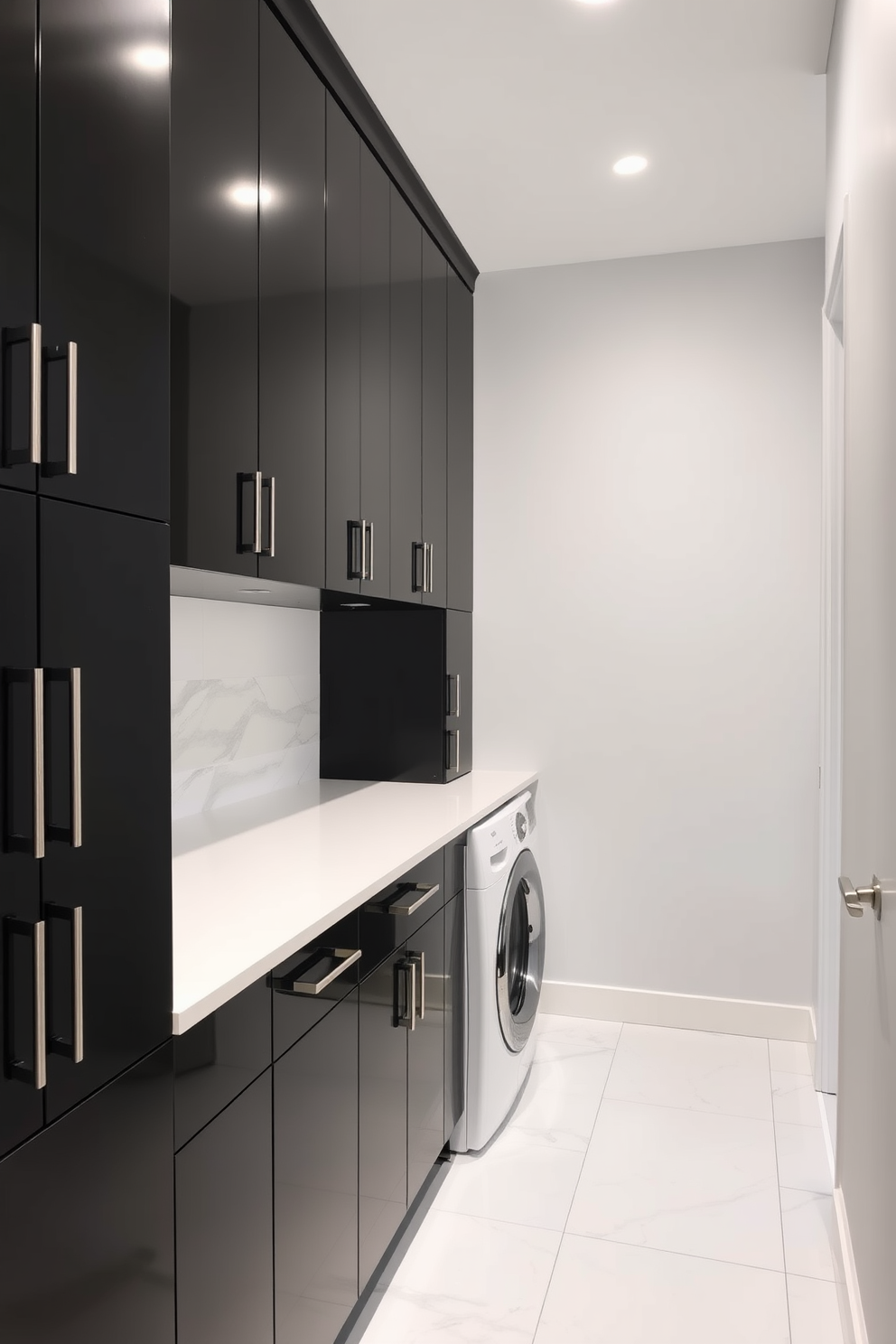 Sleek black cabinets line the walls of a modern laundry room, creating a striking contrast against the light gray walls. The cabinets feature minimalist handles and a glossy finish, enhancing the contemporary aesthetic of the space. A spacious countertop above the cabinets provides ample space for folding laundry, while a stylish backsplash adds a touch of elegance. The floor is adorned with large white tiles, complementing the sleek design and making the room feel open and airy.