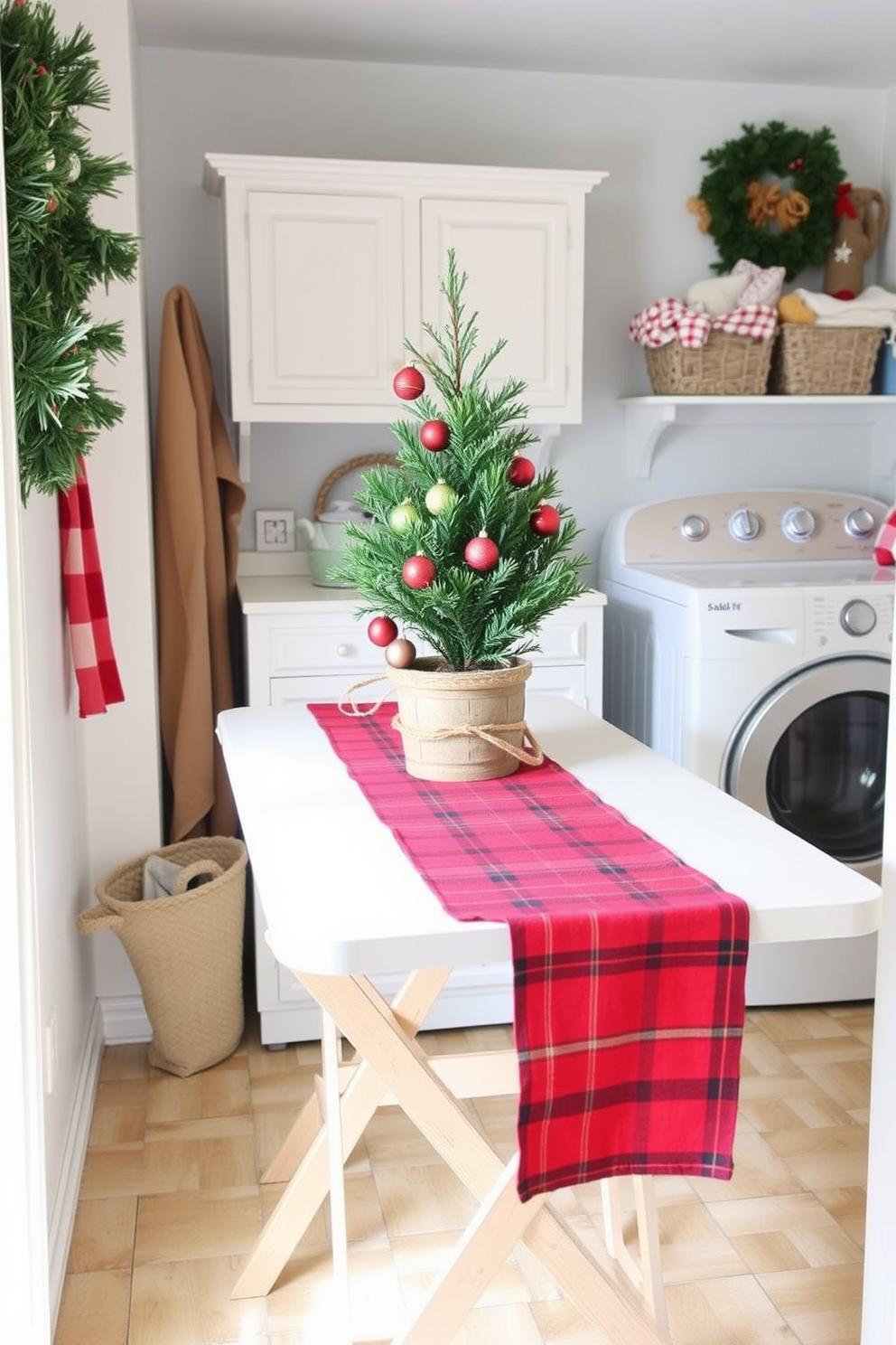 A cozy laundry room adorned for Christmas features a folding table draped with a red plaid table runner. On the table, there are festive decorations, including a small evergreen tree in a rustic pot and a collection of colorful ornaments.