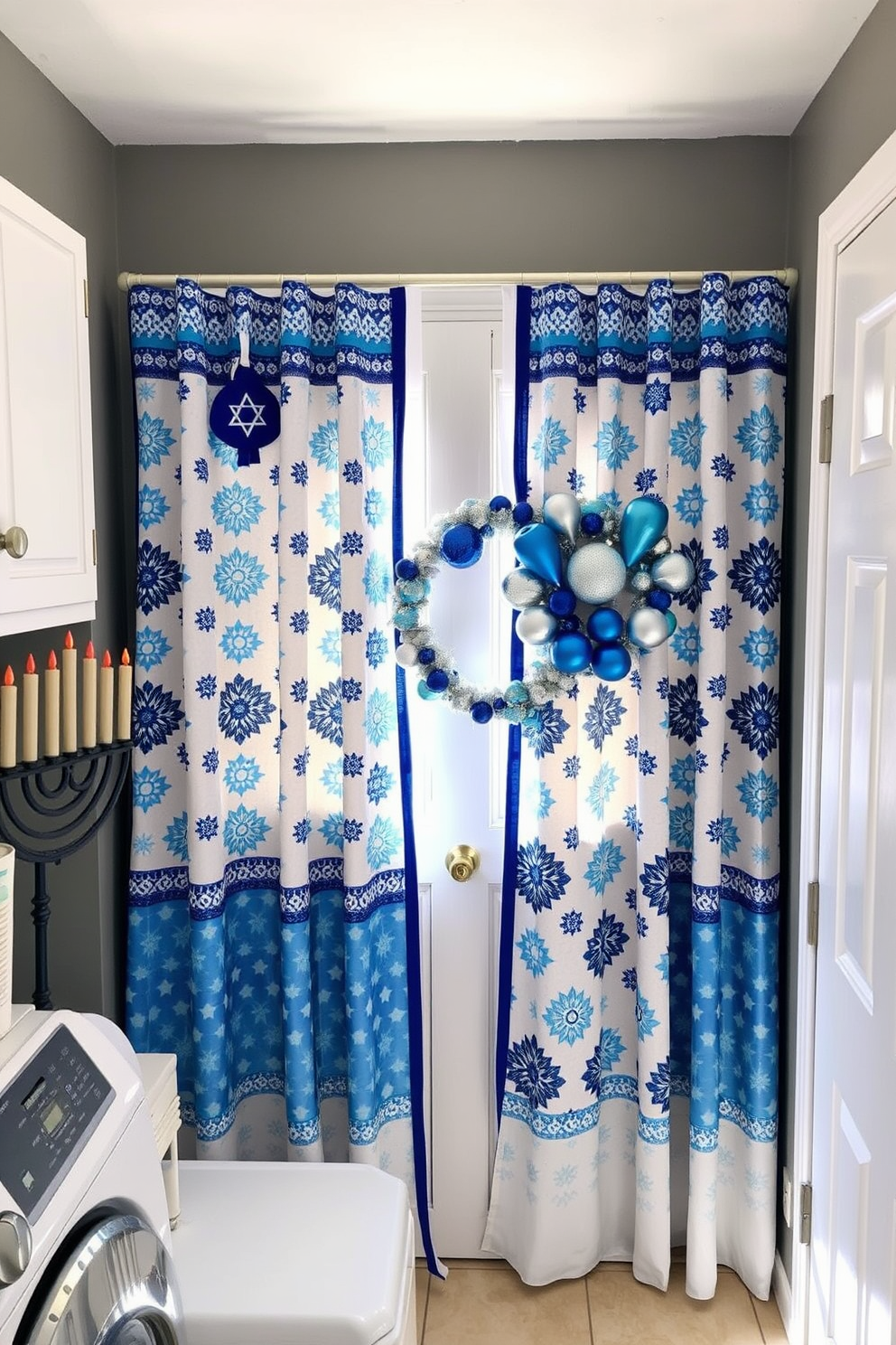 A cozy laundry room adorned with Hanukkah themed fabric curtains featuring blue and white patterns. The space is brightened by natural light filtering through the curtains, creating a festive atmosphere. The walls are painted in a soft gray, complementing the colorful curtains. Decorative elements include a menorah on the countertop and a wreath made of blue and silver ornaments hanging on the door.