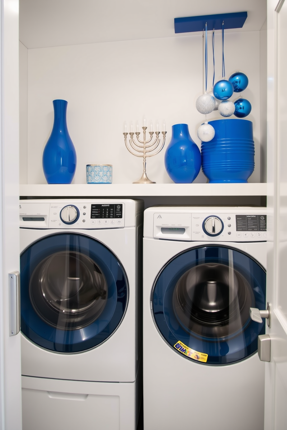 A stylish laundry room featuring blue and silver accessories. The walls are painted a soft white, and the cabinets are adorned with sleek silver handles. Incorporate festive Hanukkah decorations that blend seamlessly with the modern design. A menorah is placed on a shelf, complemented by blue and silver ornaments hanging nearby.