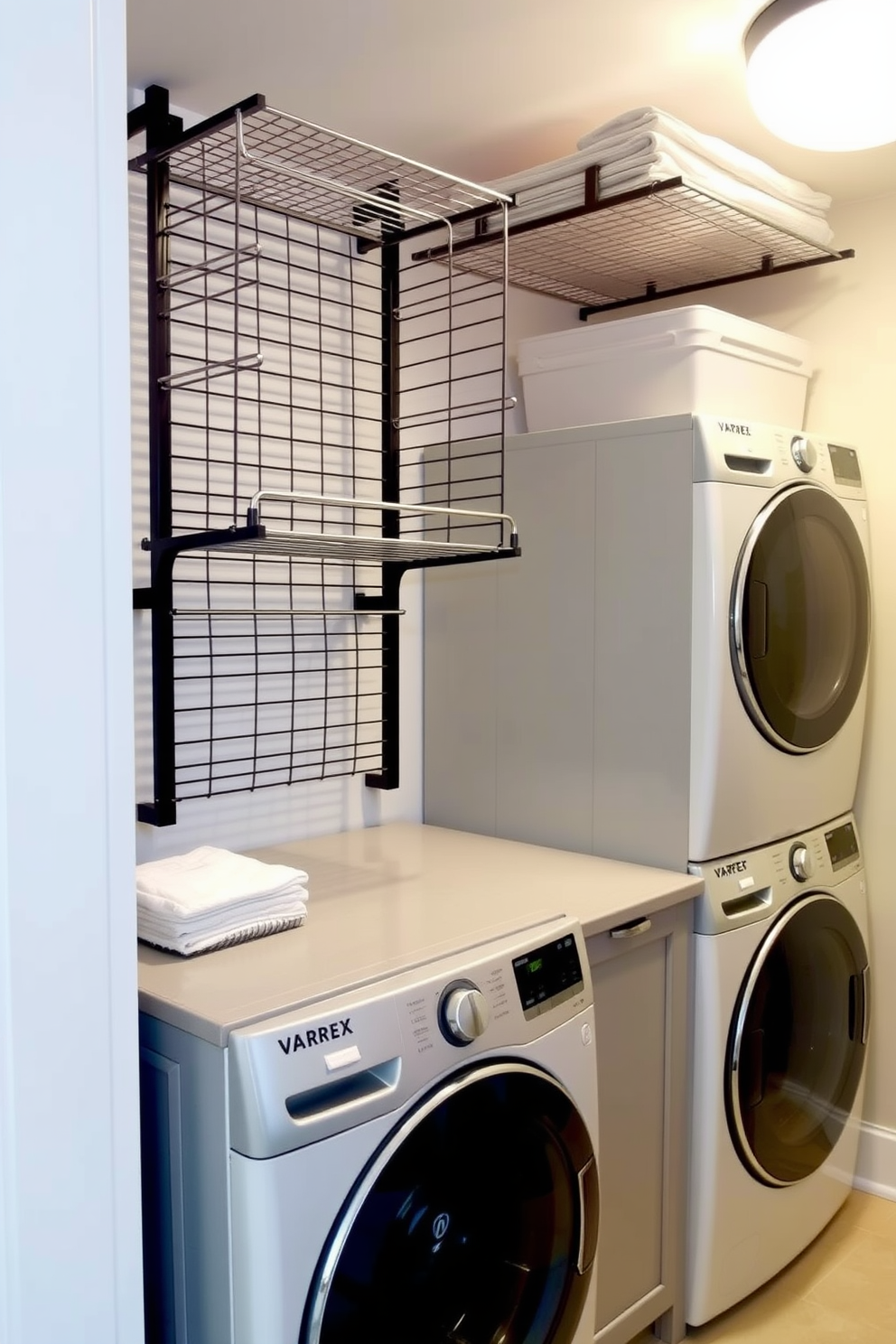 A modern laundry room featuring wall-mounted drying racks for convenience. The space includes a stacked washer and dryer, with sleek cabinetry in a soft gray finish and a countertop for folding clothes.