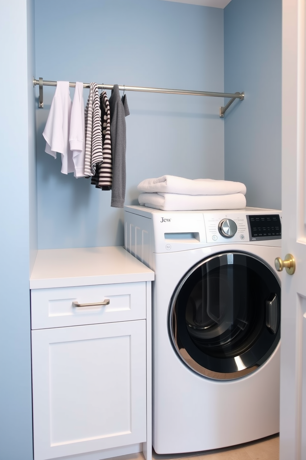 Open concept design for a spacious feel. The laundry room features a top loading washer surrounded by custom cabinetry in a light wood finish. Bright white walls enhance the airy atmosphere while a large window allows natural light to flood the space. A stylish countertop above the washer provides ample space for folding clothes and organizing laundry essentials.