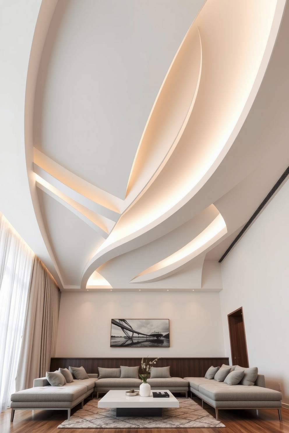 A living room with a striking sculptural ceiling that draws the eye upward. The ceiling features a dynamic design with layered elements in white and wood finishes, creating depth and interest. Soft ambient lighting is integrated into the ceiling design, casting a warm glow throughout the space. Below, the room is furnished with a plush sectional sofa and a modern coffee table, complementing the ceiling's artistic flair.