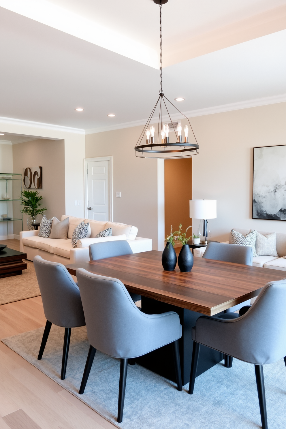 A spacious living room and dining room combo featuring an open layout that seamlessly blends both spaces. The walls are painted in soft beige, complemented by a plush cream sectional sofa adorned with textured throw pillows. In the dining area, a sleek wooden table is surrounded by modern upholstered chairs in muted gray. A stylish pendant light hangs above the table, casting a warm glow over the space while a large piece of abstract art adorns the wall.