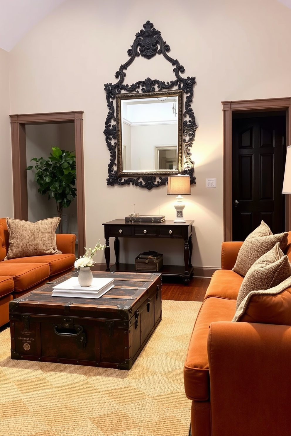 A vintage trunk serves as a unique coffee table in a cozy living room. Surrounding the trunk, plush seating in warm earth tones creates an inviting atmosphere, complemented by soft throw pillows and a textured area rug. In the entryway, a statement mirror with an ornate frame hangs above a narrow console table. The table is adorned with a few carefully selected decor items, including a small potted plant and a vintage lamp, enhancing the charm of the space.