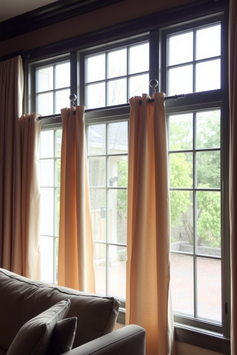 A bright and airy living room featuring large framed mirrors strategically placed to reflect natural light. The windows are elegantly dressed with sheer white curtains that gently diffuse sunlight, creating a warm and inviting atmosphere.