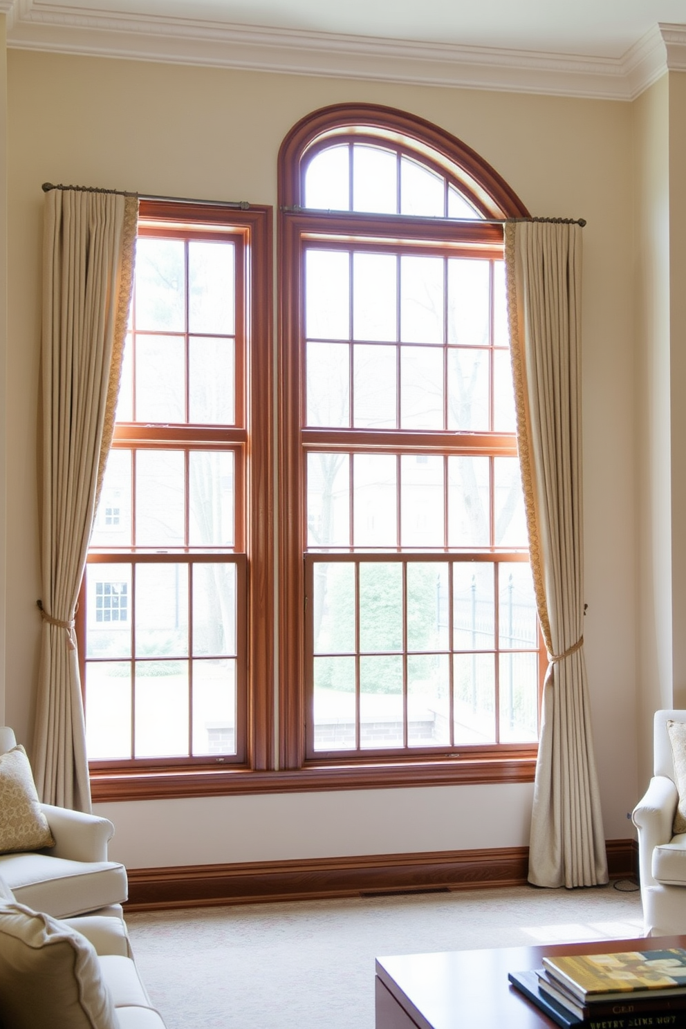 A classic living room featuring double-hung windows that allow natural light to flood the space. The windows are adorned with elegant drapes in a soft neutral color, complementing the rich wooden trim around them.