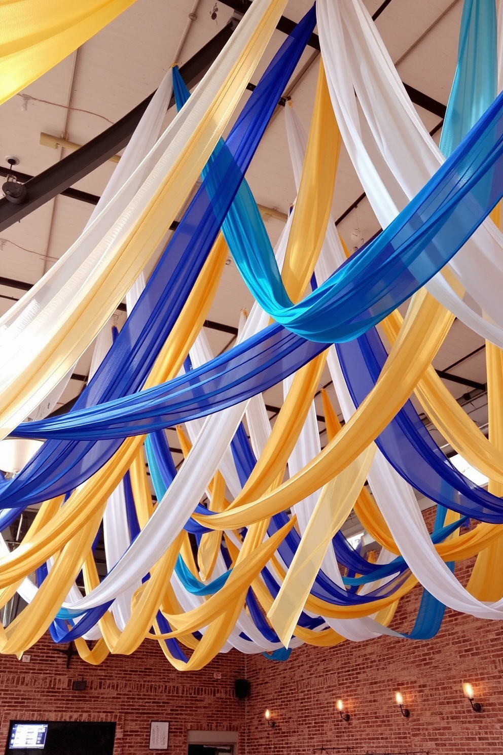 Colorful fabric banners hang gracefully from the ceilings, creating a vibrant and festive atmosphere for the celebration. The banners feature a mix of rich blues, golds, and whites, complementing the overall decor while adding a touch of elegance to the loft space.