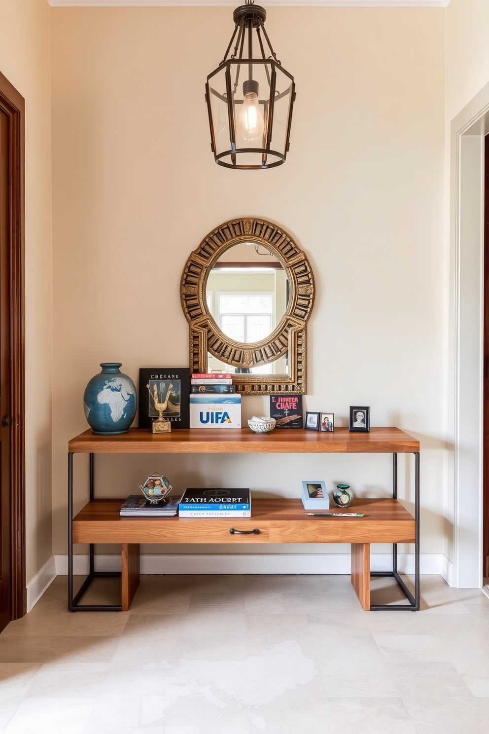 A long foyer featuring a sleek console table made of reclaimed wood, adorned with travel souvenirs from around the world. The walls are painted in a soft beige, and a large mirror with an ornate frame reflects the warm light from a stylish pendant lamp above.