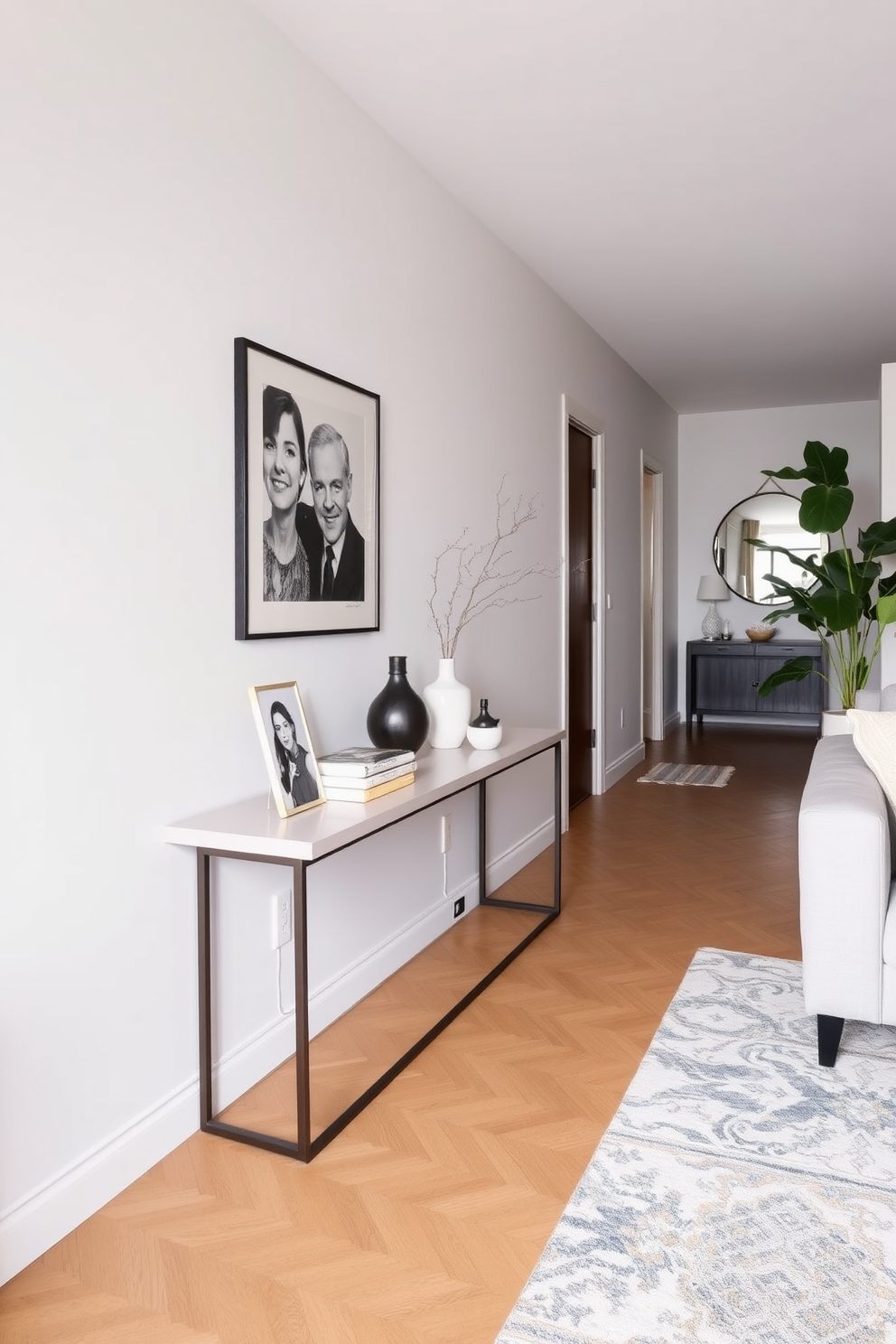 A stylish long narrow living room features a sleek console table placed against the wall. The table is adorned with decorative items such as a vase and a few art books, creating an inviting focal point.