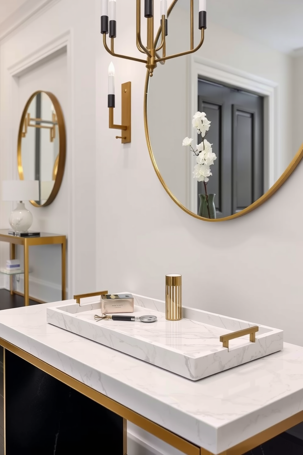 A luxury foyer design featuring a decorative tray for keys and essentials. The tray is made of polished marble and is placed on a sleek console table with gold accents.