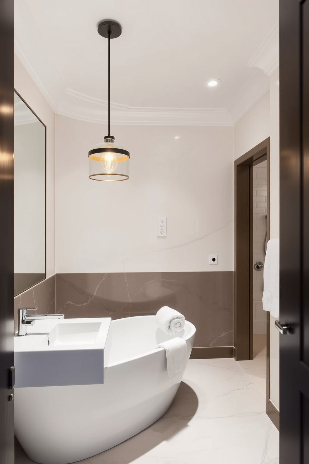 A luxury guest bathroom featuring chic pendant lighting gracefully hanging over the sink. The space is adorned with elegant finishes, including a sleek freestanding bathtub and plush towels neatly arranged for a sophisticated touch.