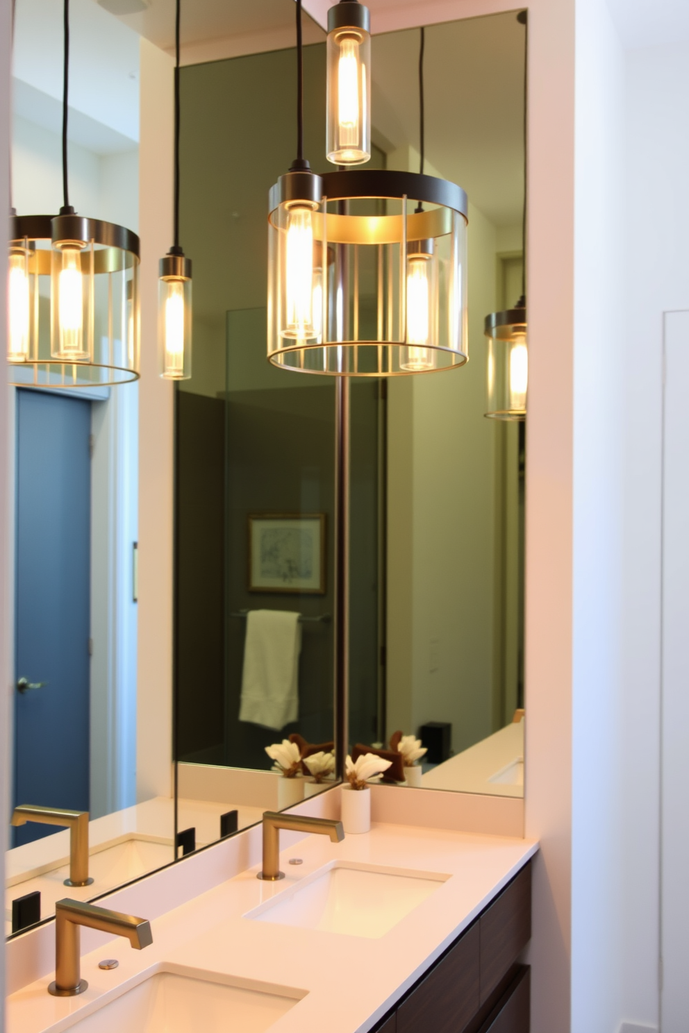 A master bathroom featuring stylish pendant lighting gracefully suspended over a sleek vanity. The space is adorned with modern finishes, including a large mirror that reflects the elegant light, creating a warm and inviting atmosphere.