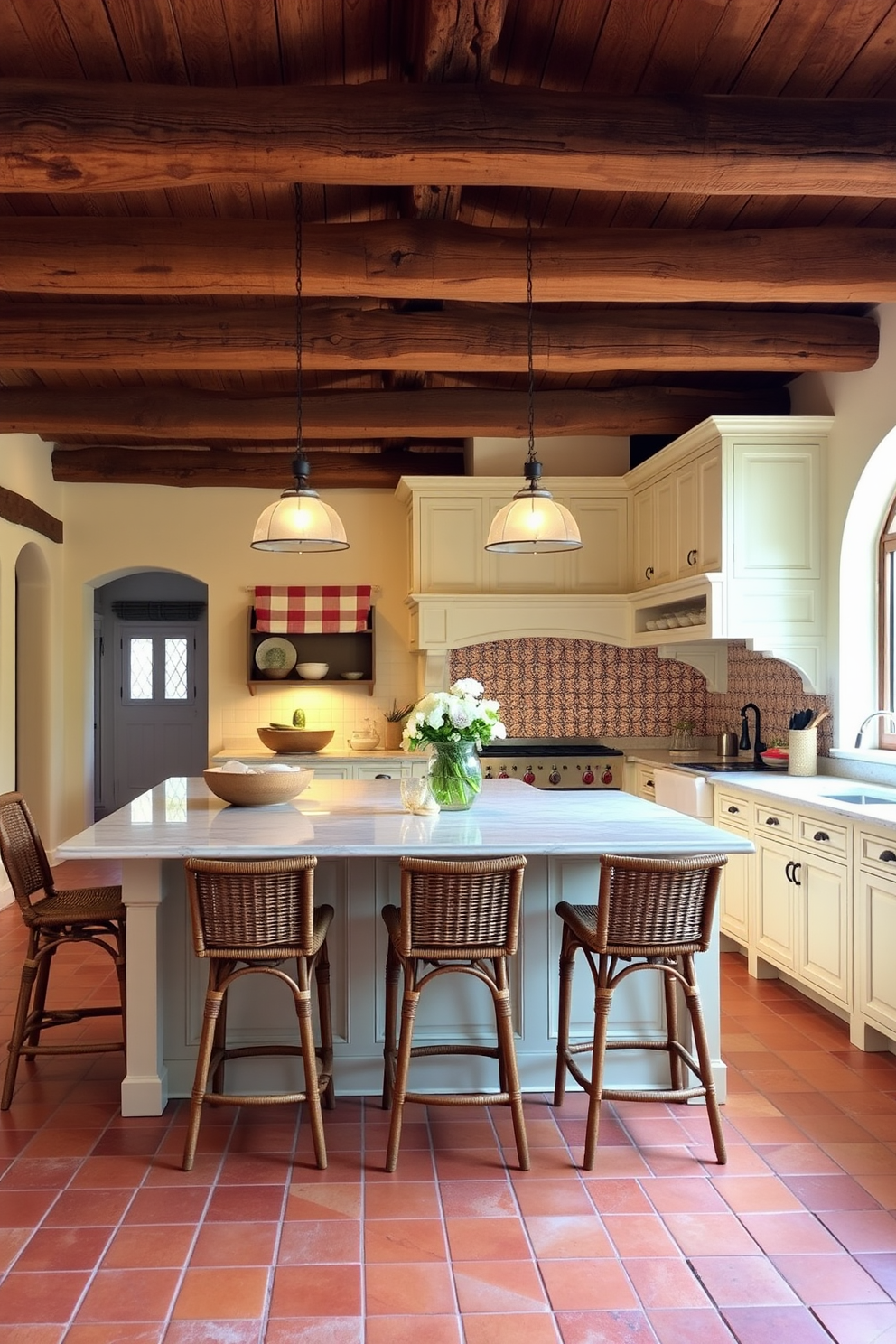 A Mediterranean kitchen with soft lighting creates a warm and inviting atmosphere. The space features rustic wooden beams overhead and terracotta tiles underfoot, complemented by creamy white cabinetry. A large island with a marble countertop serves as the centerpiece, surrounded by wicker bar stools. Decorative ceramic tiles in vibrant colors adorn the backsplash, adding a touch of charm to the overall design.