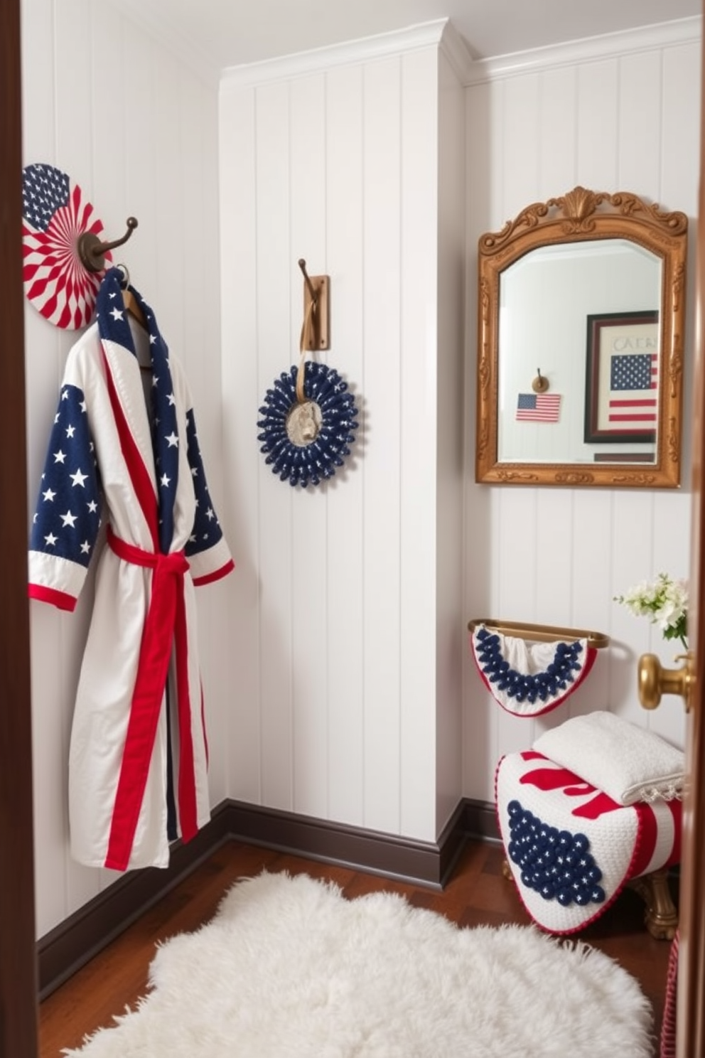 A stylish bathroom featuring a red white and blue bathrobe hanging on a wooden hook beside a vintage-style mirror. The walls are adorned with patriotic-themed artwork and the floor is covered with a soft white rug, creating a cozy and festive atmosphere for Memorial Day.