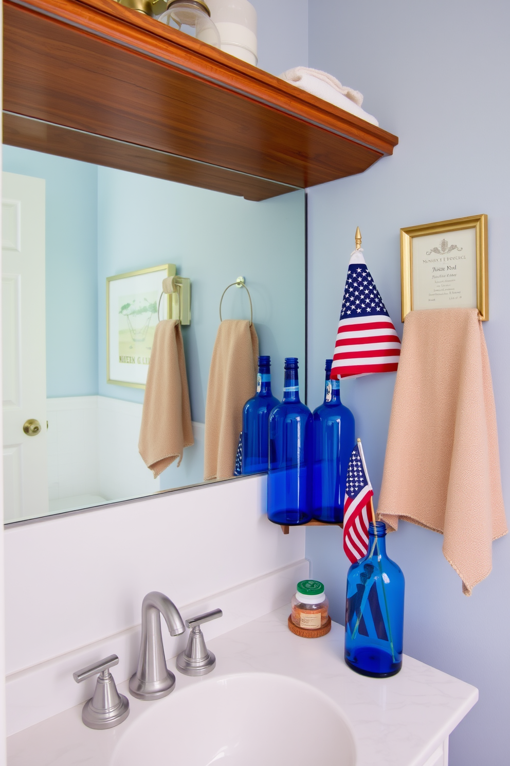 Create a serene bathroom atmosphere featuring blue glass bottles as decorative accents. The bottles are arranged on a wooden shelf above the sink, complementing the white marble countertop and soft blue walls. Incorporate Memorial Day themes with subtle patriotic elements. A small flag is displayed next to the blue glass bottles, adding a festive touch to the overall decor.