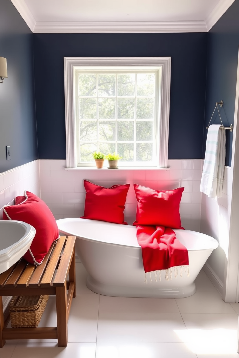 A serene bathroom setting featuring a sleek white bathtub positioned next to a large window that lets in natural light. The space is accented with red pillows on wooden benches, creating a warm and inviting atmosphere for Memorial Day celebrations. The walls are adorned with subtle navy blue accents, complementing the red pillows while maintaining a fresh and clean look. A small potted plant sits on the windowsill, adding a touch of greenery to the overall decor.