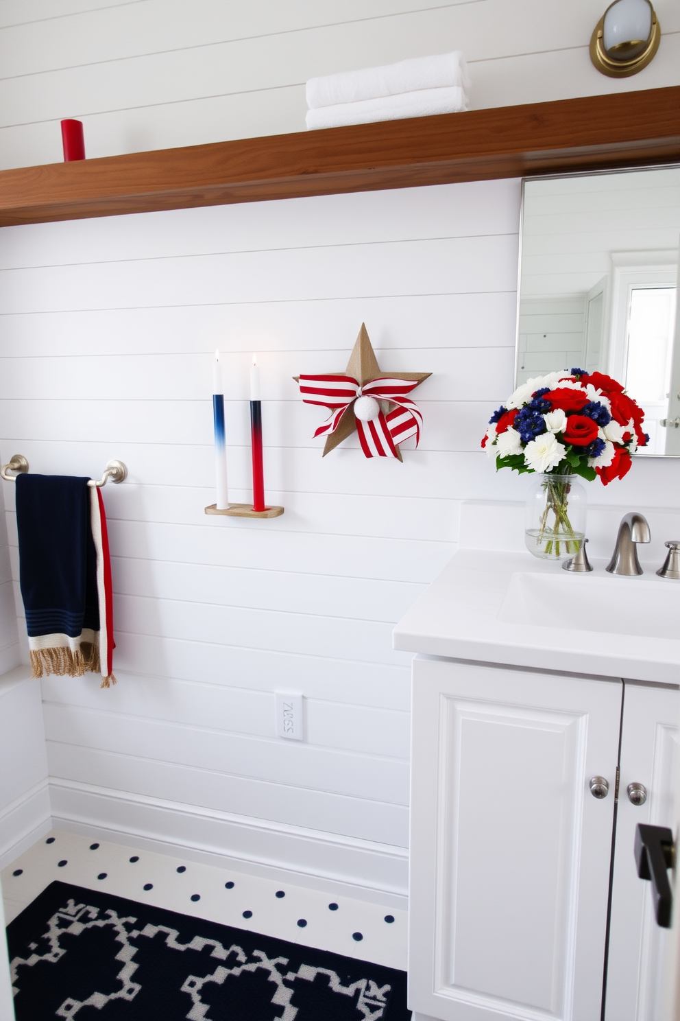 A vibrant bathroom setting featuring red white and blue floral arrangements. The decor is inspired by Memorial Day, with a cheerful display of flowers in a large vase on the countertop. The walls are painted in a soft white hue, creating a fresh and inviting atmosphere. Accents of blue and red are incorporated through towels and decorative elements, enhancing the festive theme.