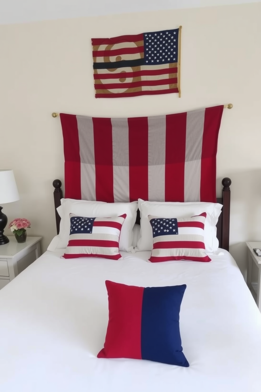 A cozy bedroom featuring a large bed adorned with patriotic throw pillows in red, white, and blue. The walls are painted a soft beige, and a festive wreath hangs above the headboard, celebrating Memorial Day.