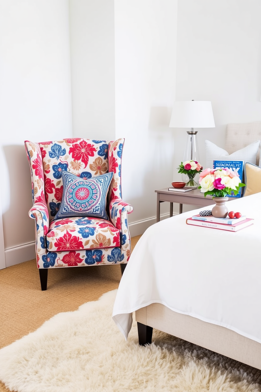 A cozy bedroom featuring an accent chair with bold patterns that adds a pop of color to the space. The walls are painted in a soft white, and a plush area rug lies beneath the chair, creating a warm and inviting atmosphere. Decorative pillows in complementary colors are arranged on the bed, enhancing the festive Memorial Day theme. A small side table next to the chair holds a patriotic-themed book and a vase of fresh flowers, completing the look.