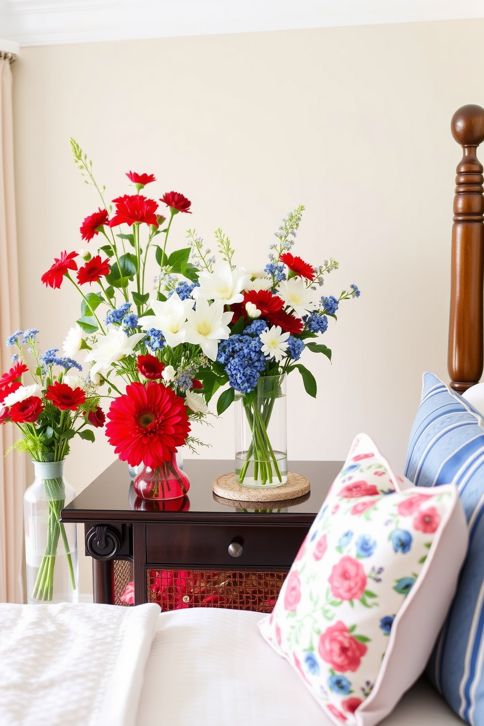 A cozy bedroom adorned with patriotic-themed decor. The bed is layered with soft blankets in red, white, and blue, creating a warm and inviting atmosphere. On the walls, framed art featuring American flags adds a festive touch. A rustic wooden nightstand holds a small bouquet of wildflowers, enhancing the overall charm of the space.