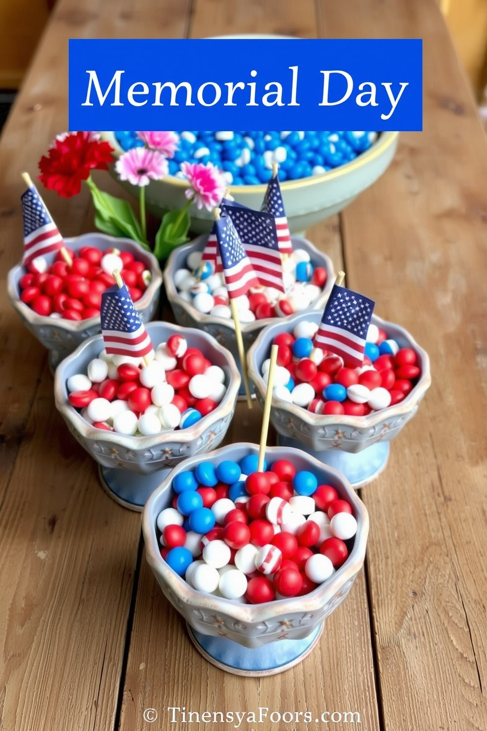 A collection of decorative bowls filled with red white and blue candies is displayed on a rustic wooden table. The bowls are arranged with festive accents such as small American flags and fresh flowers for a vibrant Memorial Day celebration.