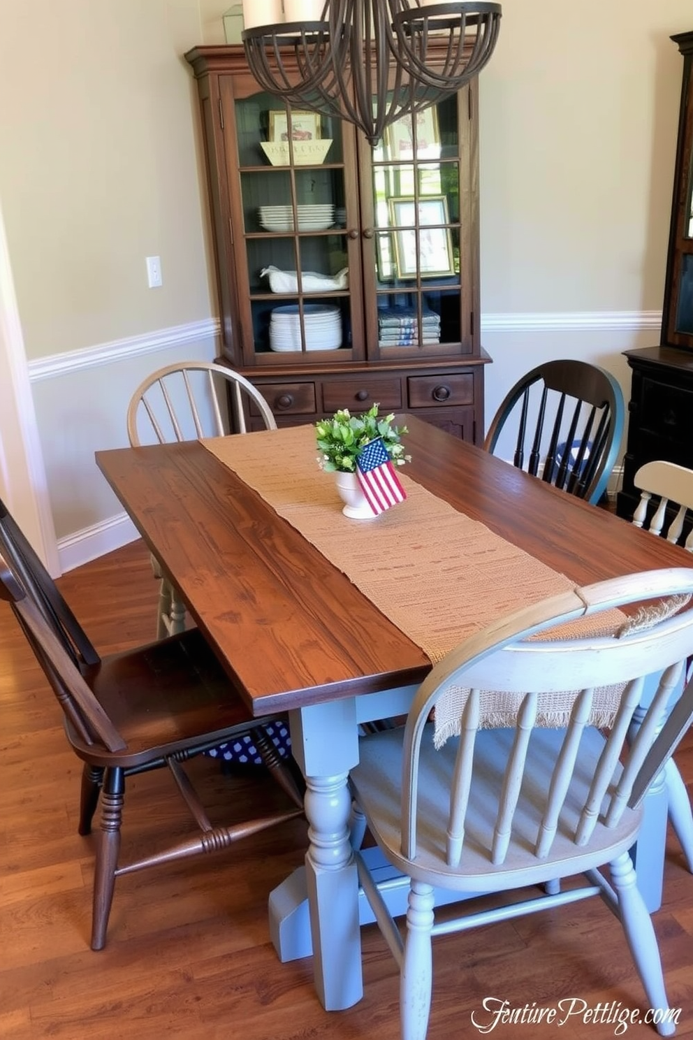 A festive dining room setting for Memorial Day. The table is elegantly set with red chargers, white plates, and blue napkins, creating a patriotic color scheme. Centerpiece arrangements of fresh flowers in red, white, and blue are placed on the table. Soft candlelight flickers from decorative holders, adding warmth to the atmosphere.