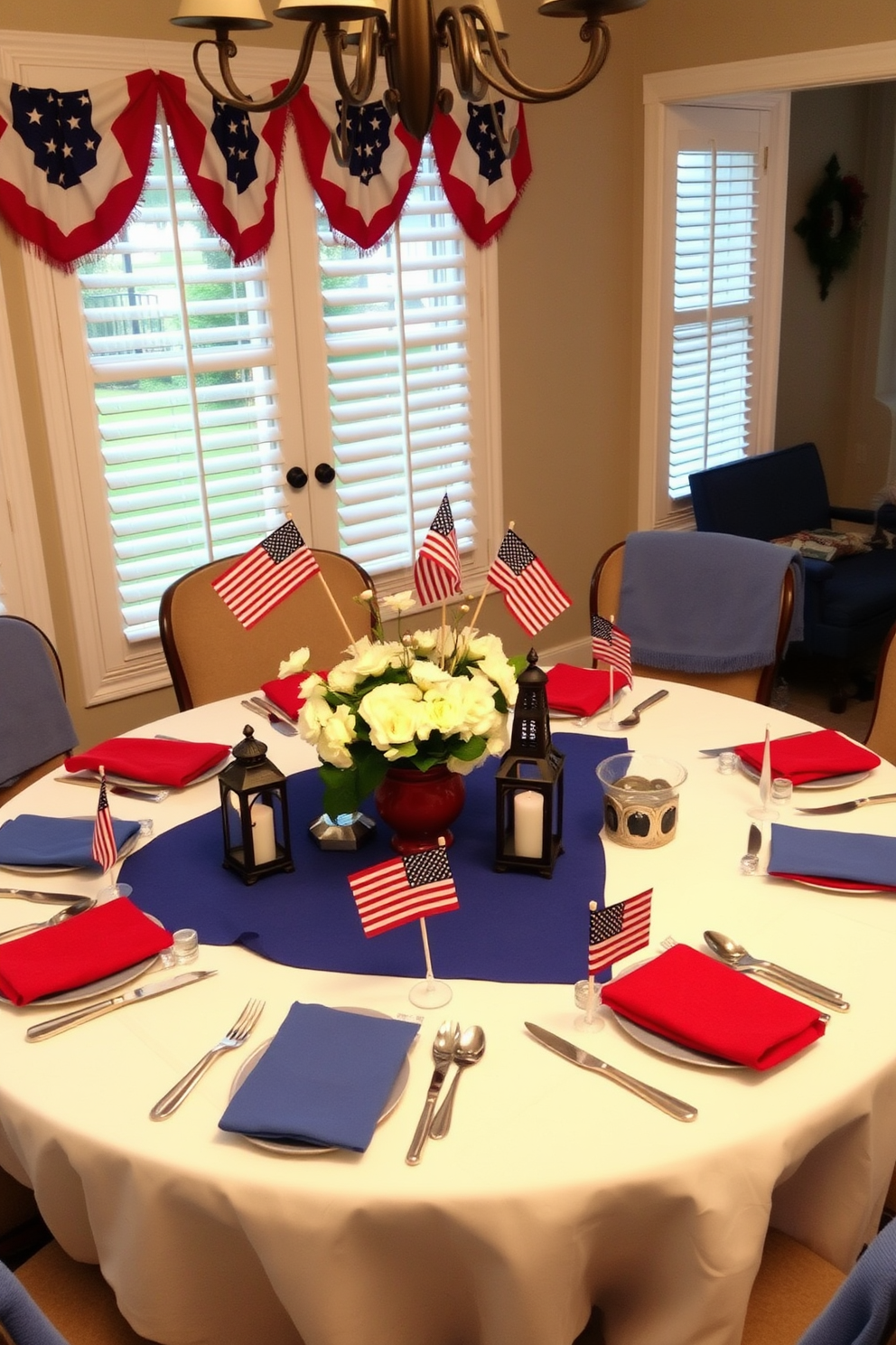 A festive dining room setting for Memorial Day. The table is elegantly set with a white tablecloth and adorned with vibrant red and blue accents, featuring mini American flags as place cards at each setting. Centerpieces include a mix of fresh white flowers and small decorative lanterns. Surrounding the table, comfortable chairs are draped with soft blue throws, creating a warm and inviting atmosphere.