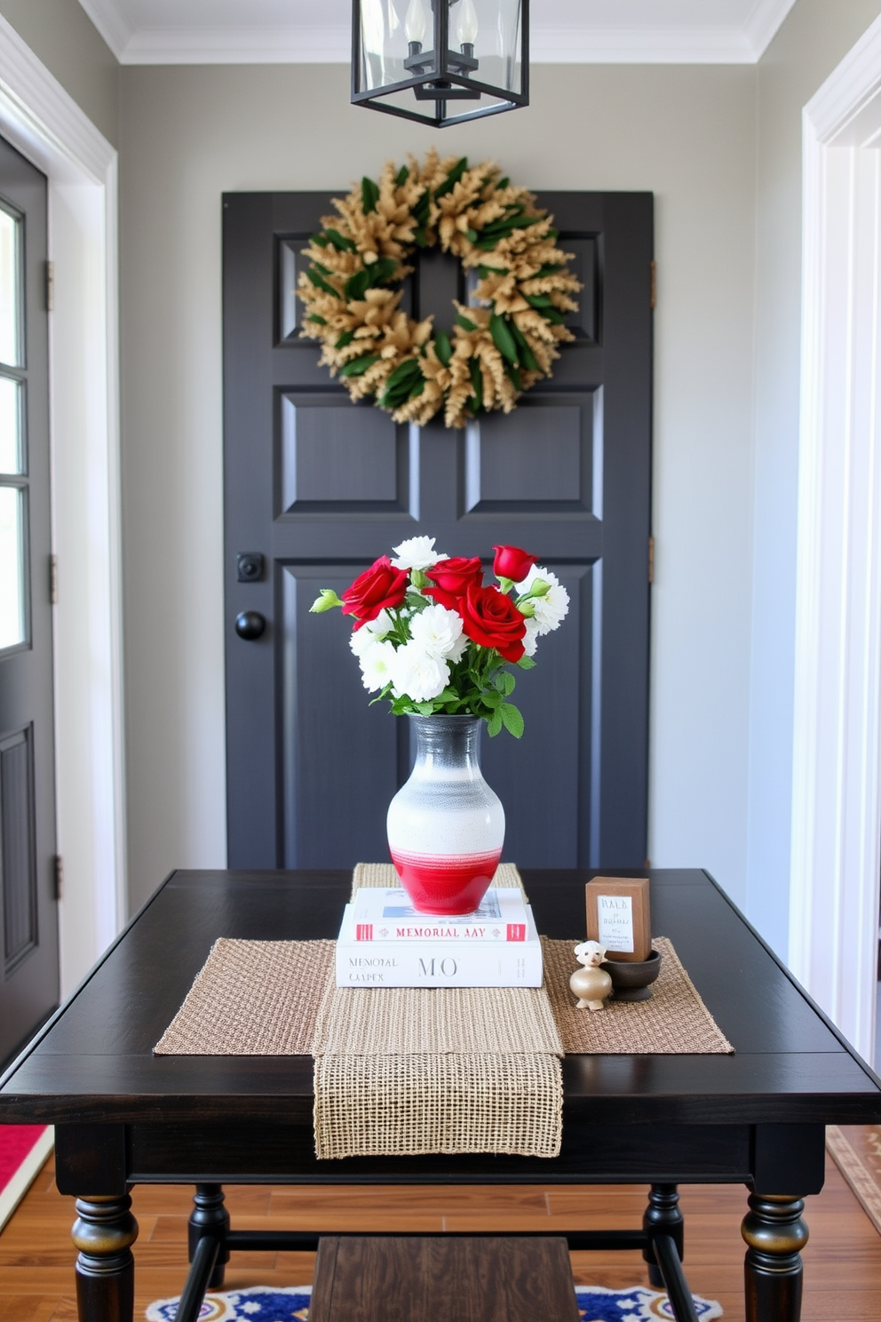 A welcoming entryway features a stylish table adorned with a vibrant red white and blue vase. The table is complemented by a rustic runner and small decorative items that evoke a sense of patriotism for Memorial Day.