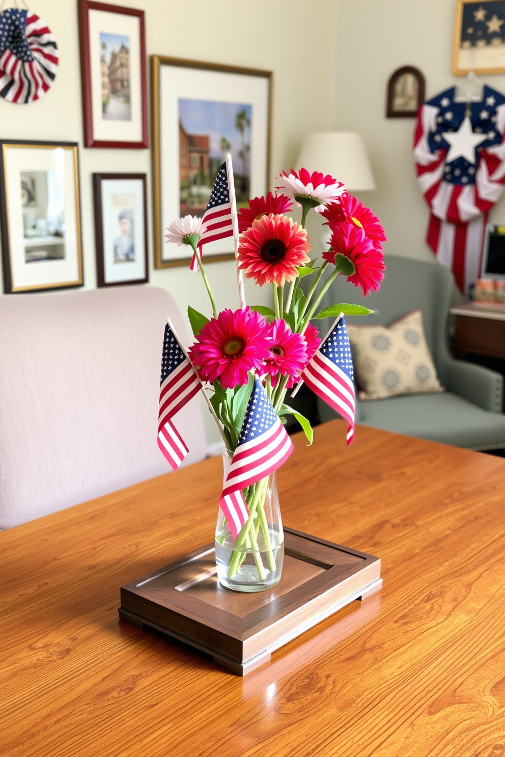 A creative centerpiece is arranged on a wooden desk featuring small American flags and vibrant flowers in a glass vase. The backdrop consists of a cozy home office with patriotic-themed decorations, including framed artwork and a comfortable chair.