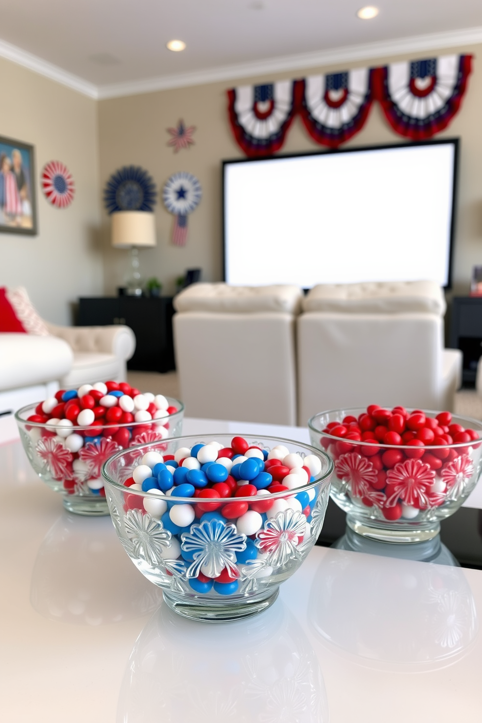 Decorative bowls filled with red white and blue candies are elegantly arranged on a sleek coffee table. The bowls are made of glass and feature intricate patterns that catch the light beautifully. In the background, a cozy home theater setup showcases plush seating and a large screen. The walls are adorned with patriotic-themed decorations, enhancing the festive atmosphere for Memorial Day celebrations.