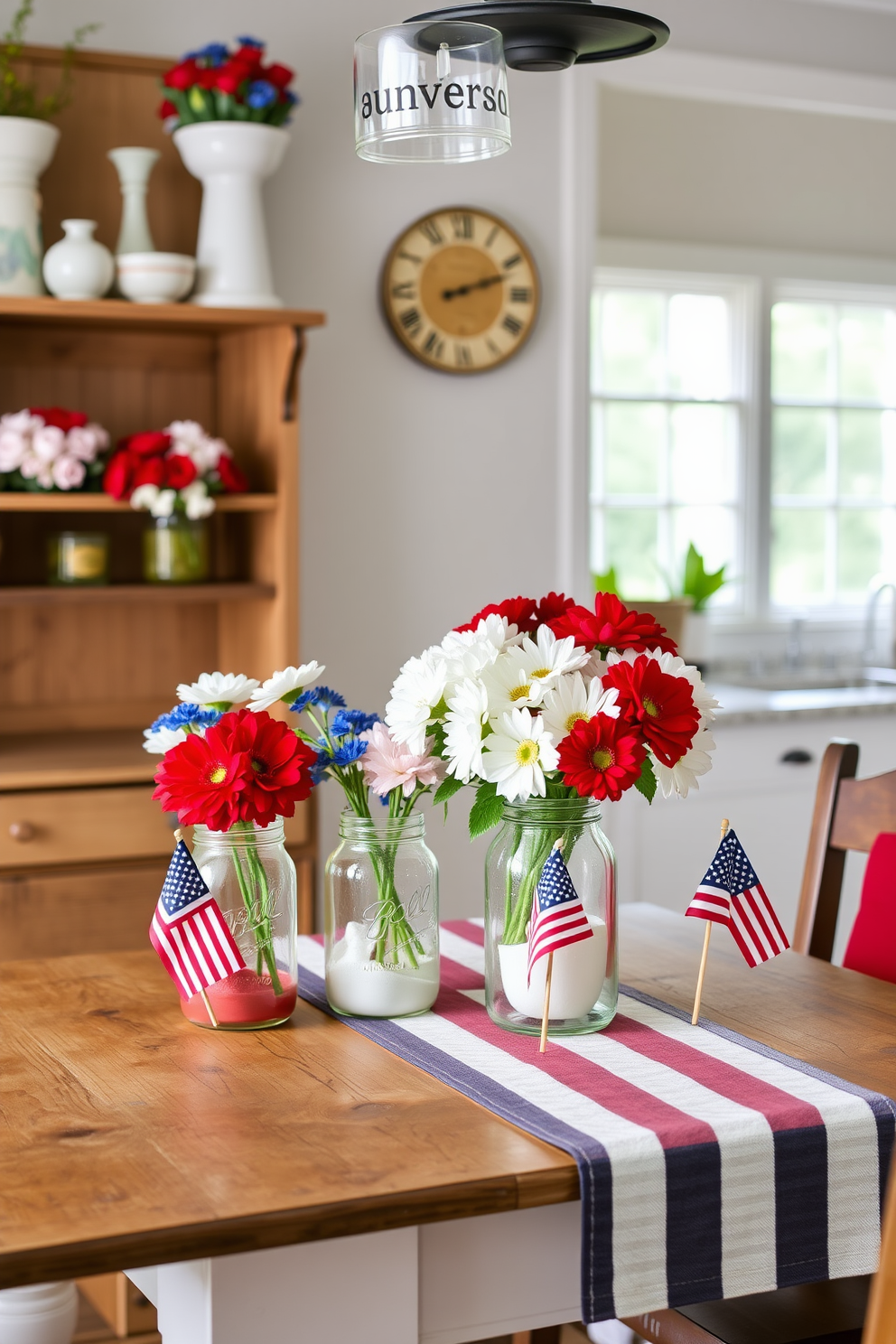 Decorative mason jars filled with red white and blue flowers are arranged on a rustic wooden shelf. The kitchen features a cheerful atmosphere with a vintage farmhouse table adorned with a striped tablecloth and small American flags.