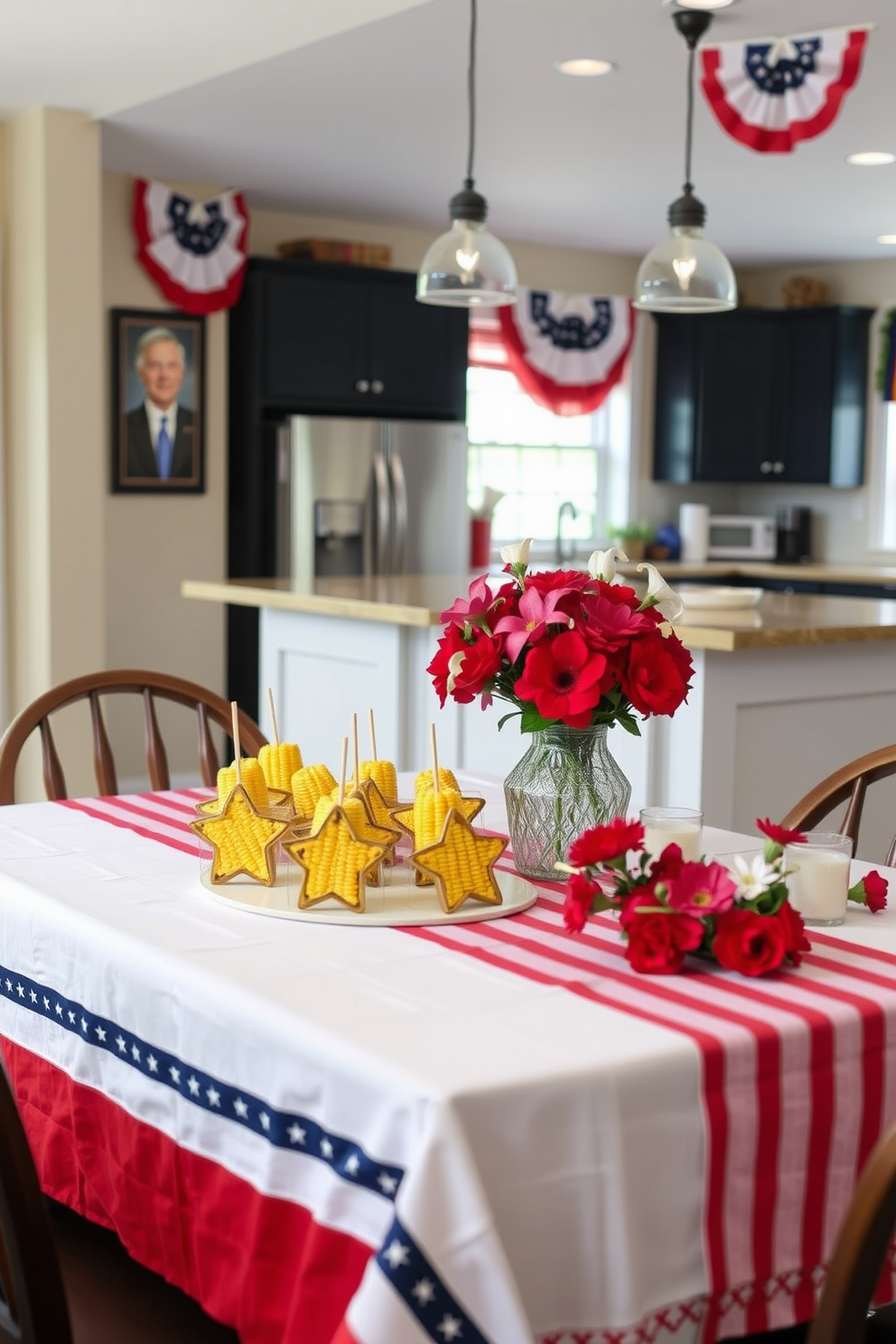 A festive kitchen setting for Memorial Day. The table is adorned with a red, white, and blue tablecloth, featuring a centerpiece of grilled corn on the cob holders shaped like stars. In the background, there are patriotic banners hanging on the walls. The kitchen island is decorated with fresh flowers in shades of red and white, creating a cheerful atmosphere for gathering.