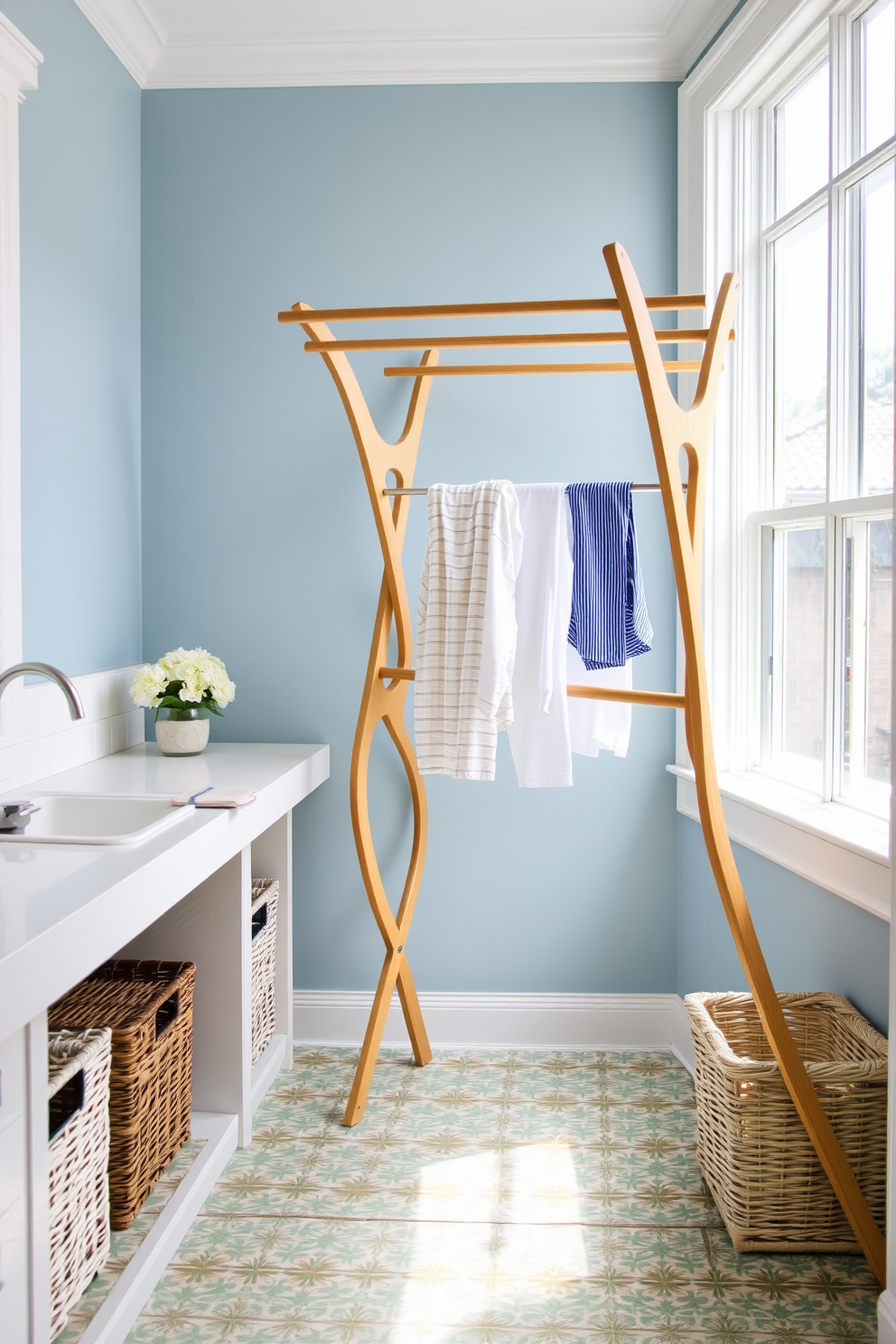 A bright and airy laundry room features a stylish drying rack made of natural wood, elegantly positioned near a large window that allows ample sunlight to filter in. The walls are painted in a soft blue hue, and the floor is adorned with cheerful patterned tiles that add a touch of whimsy to the space. To the left of the drying rack, there is a sleek white countertop with a built-in sink, perfect for pre-treating laundry. Decorative baskets made of wicker are neatly arranged underneath for storing laundry essentials, enhancing both functionality and style.